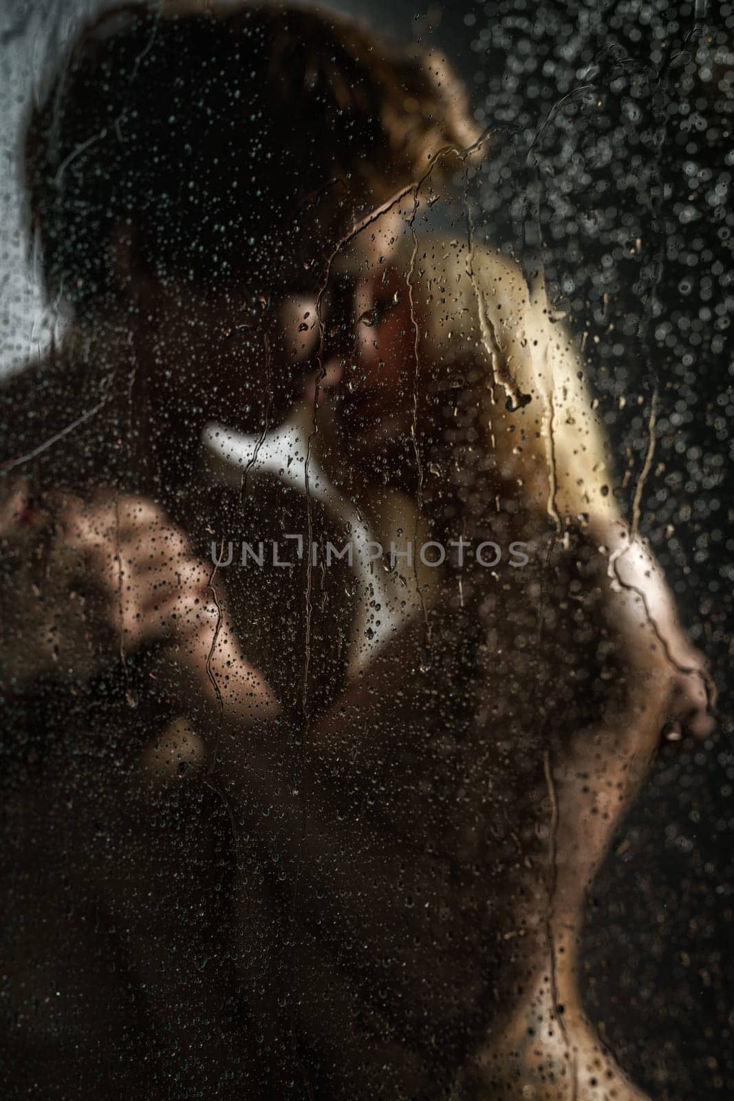 Sexy beautiful couple making love in shower studio shot