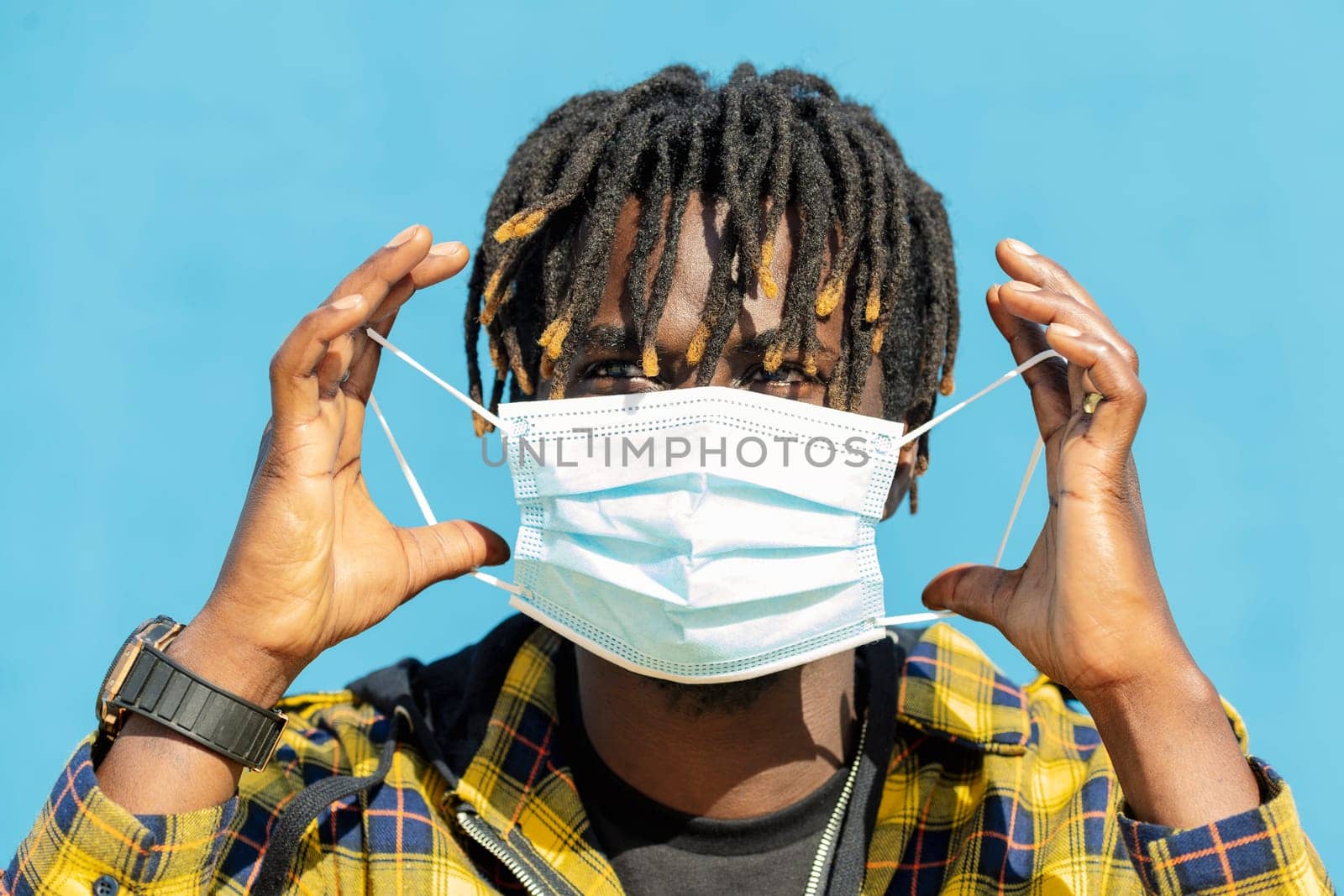 attractive young black man wearing a protective mask, lifestyle concept and virus protection