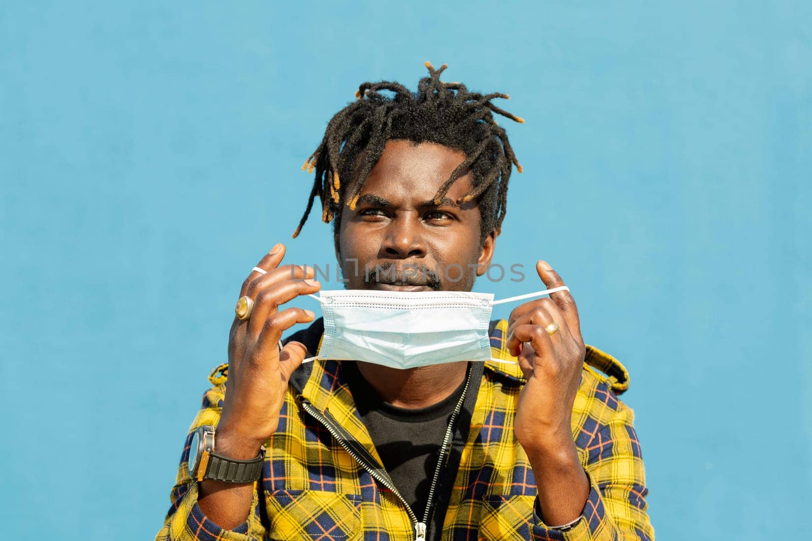 attractive young african man wearing a protective mask, lifestyle concept and virus protection