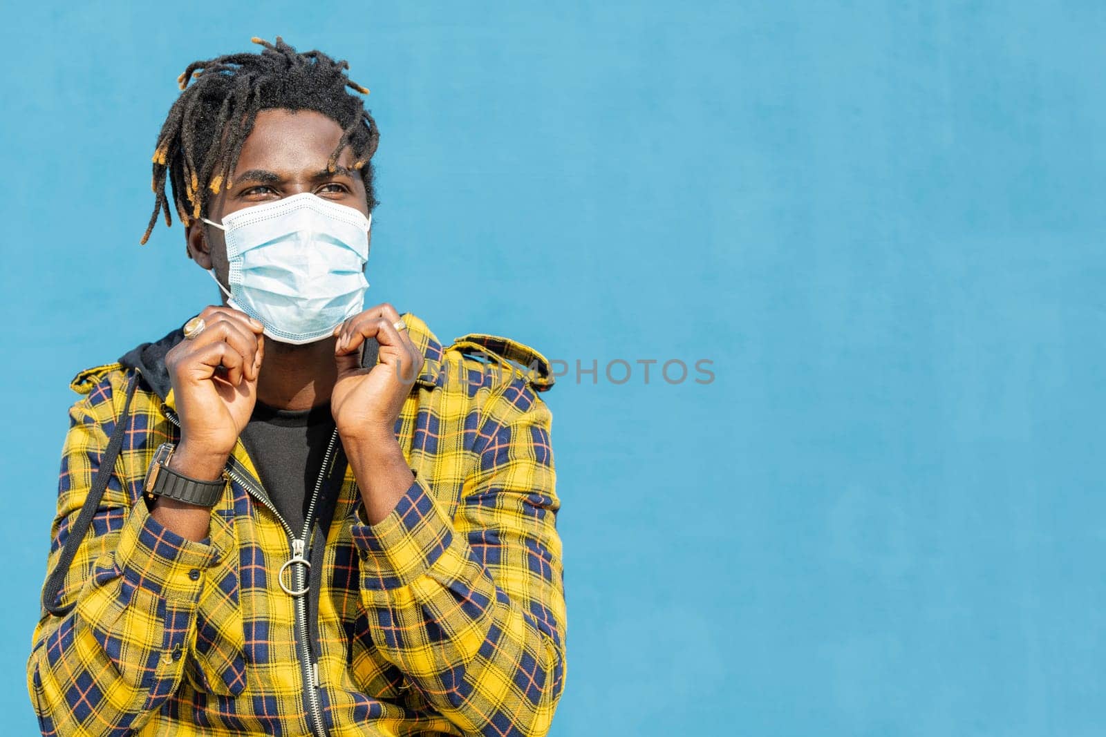 attractive young african man wearing a protective mask, lifestyle concept and virus protection, copy space for text