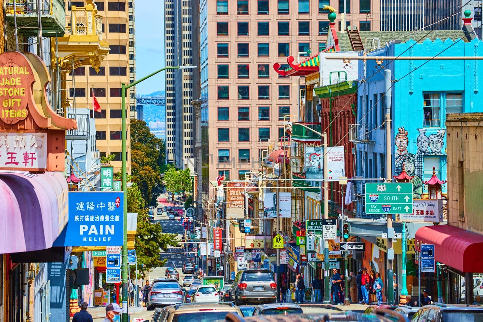 Image of Chinese and American signs along busy Chinatown street