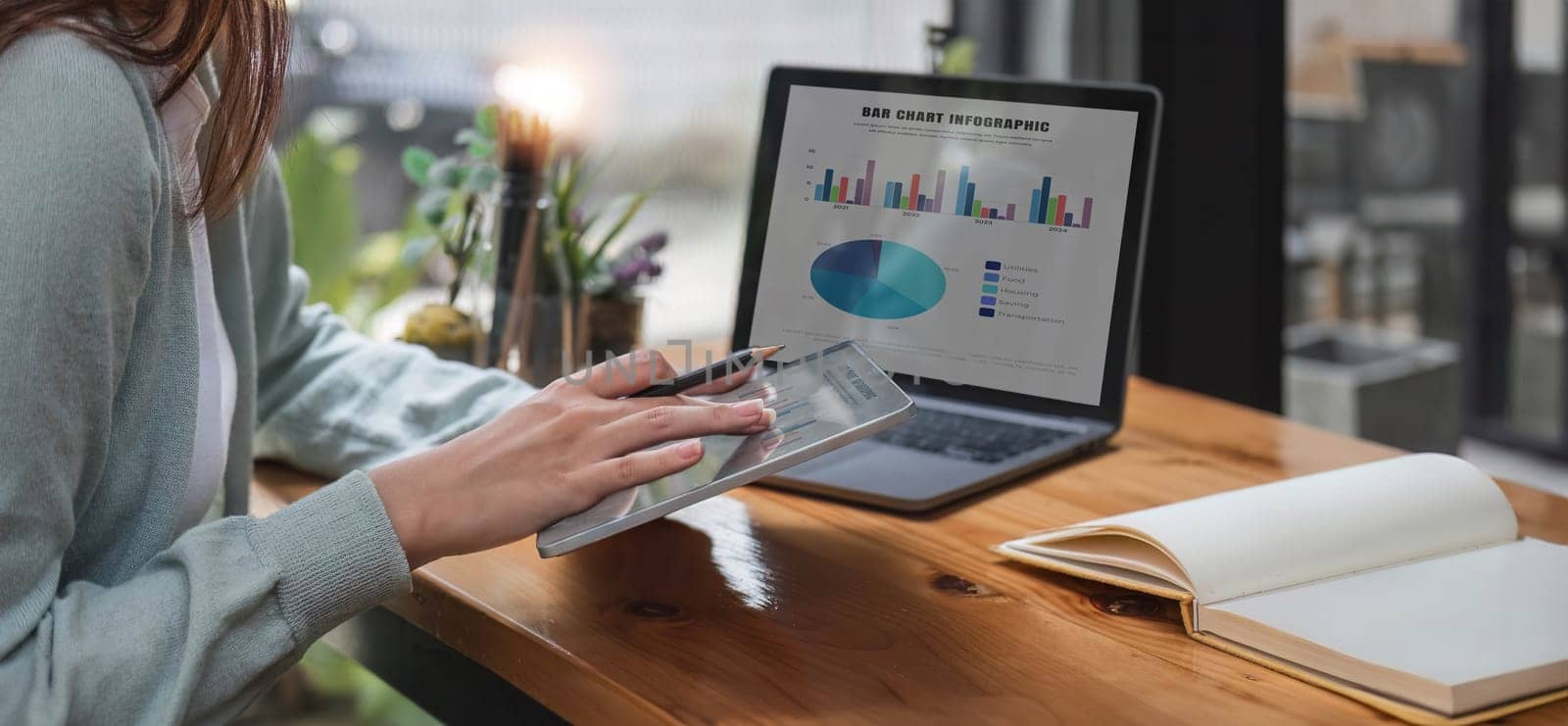 Young accountant calculates taxes, expenses and finances with results in graph form for readability. by wichayada