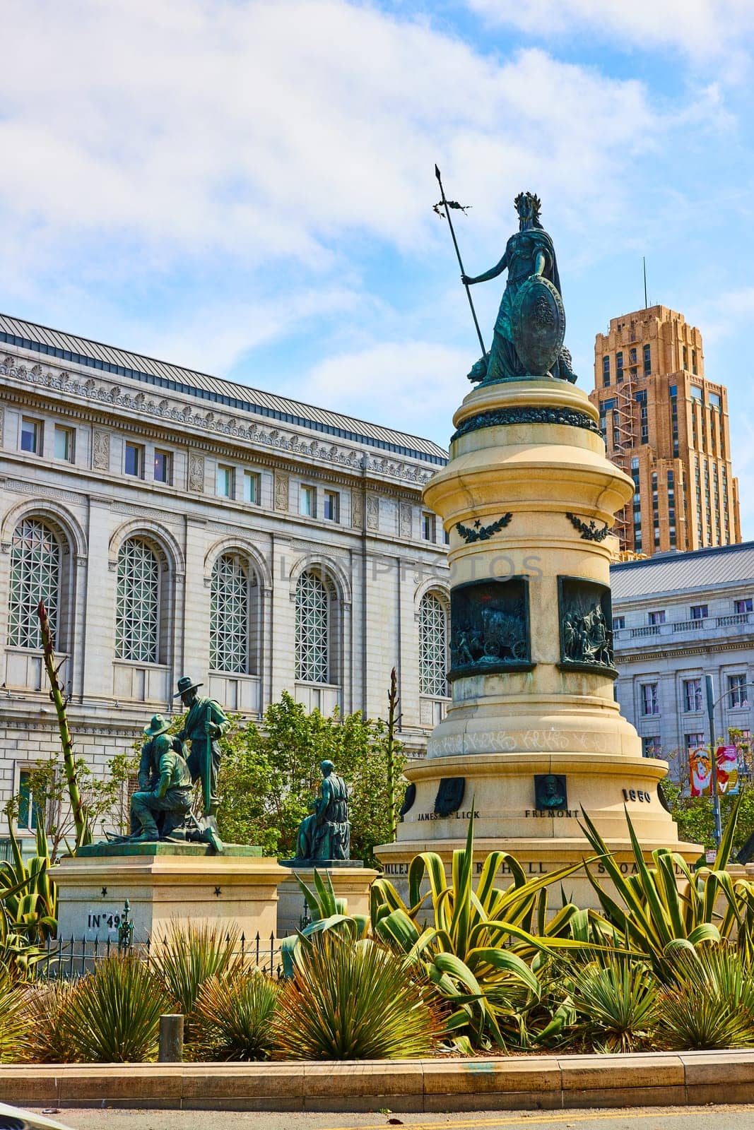 Image of Pioneer Monument on sunny day with buildings in background