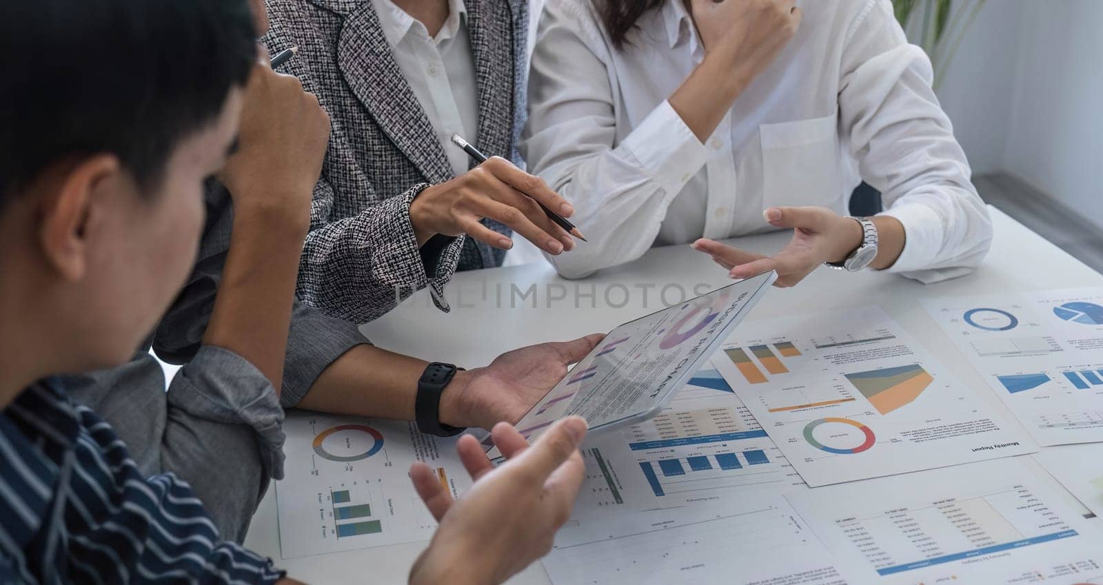 Business People Meeting using laptop computer,calculator,notebook,stock market chart paper for analysis Plans to improve quality next month. Conference Discussion Corporate Concept.