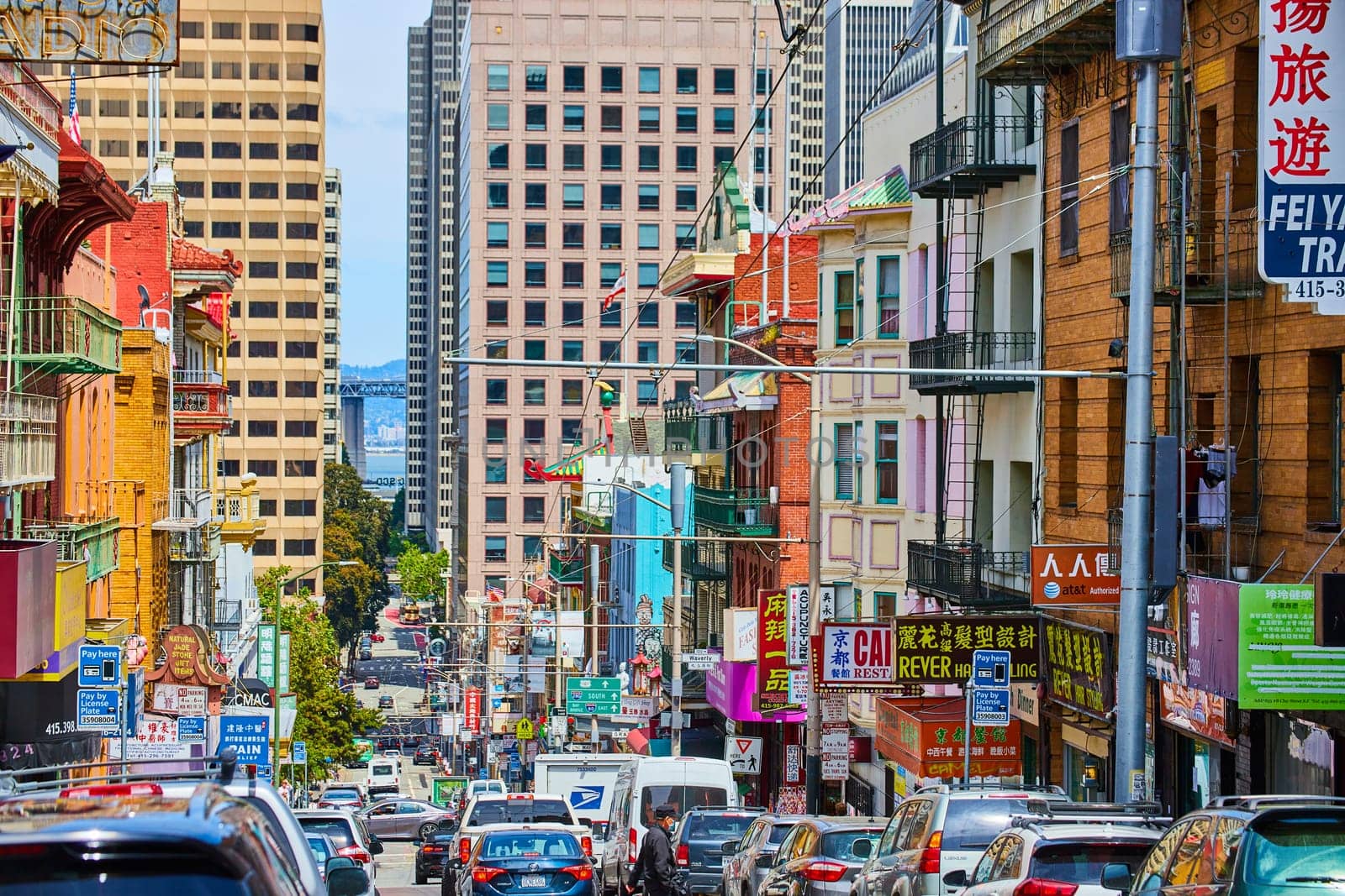 Image of Busy street in San Francisco Chinatown with distant bay waters