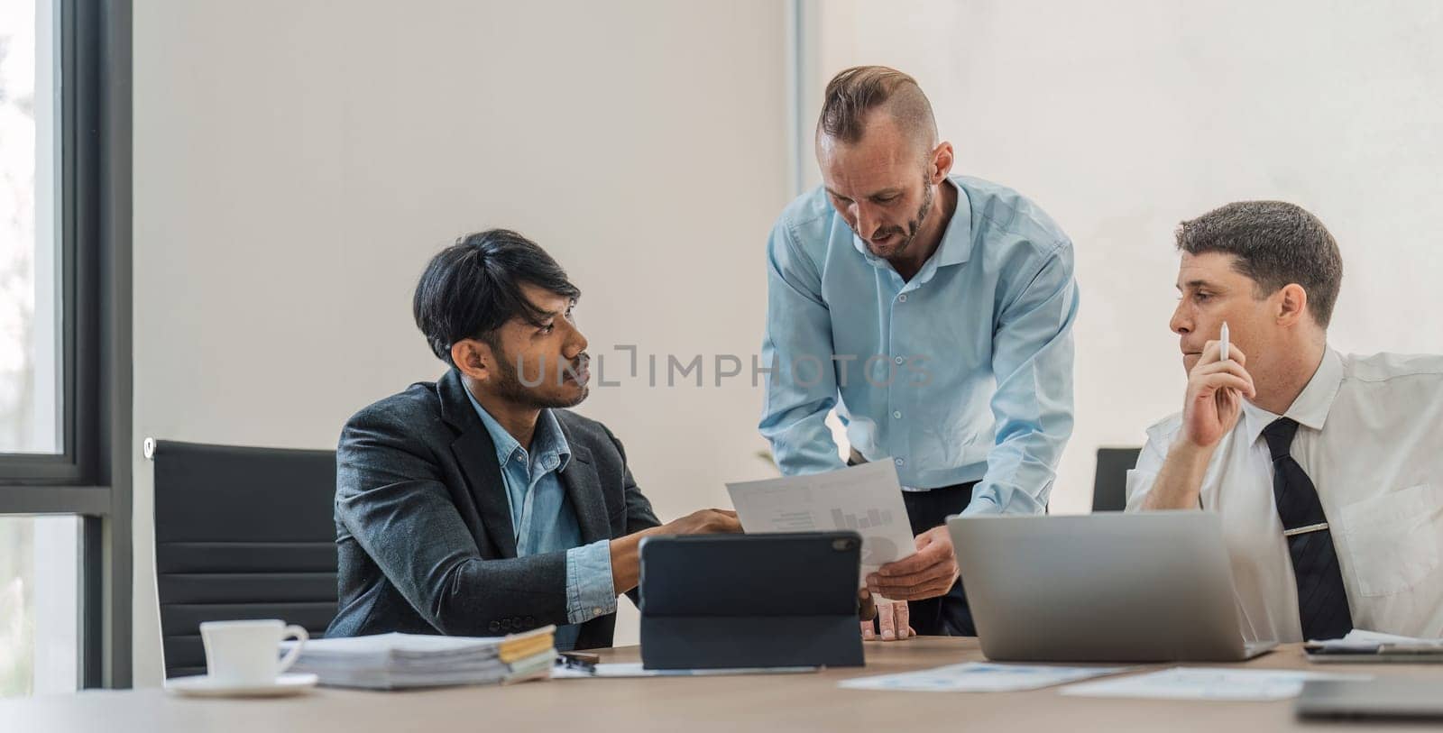 Business People Meeting using laptop computer,calculator,notebook,stock market chart paper for analysis Plans to improve quality next month. Conference Discussion Corporate Concept.