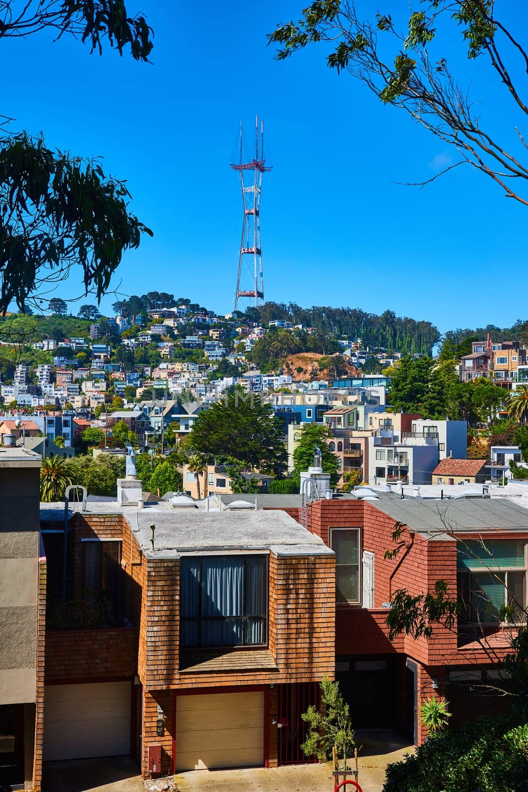 Image of Large neighborhood on hill going up to Sutro Tower on blue sky day