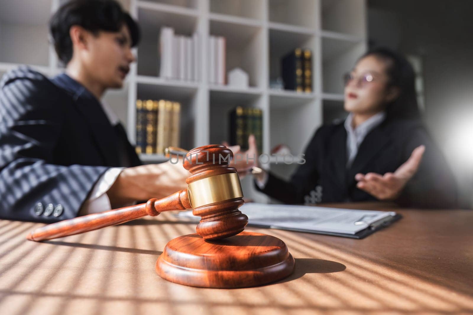 Businessman and lawyer discussing business contract document for legal advice in lawyer's office..