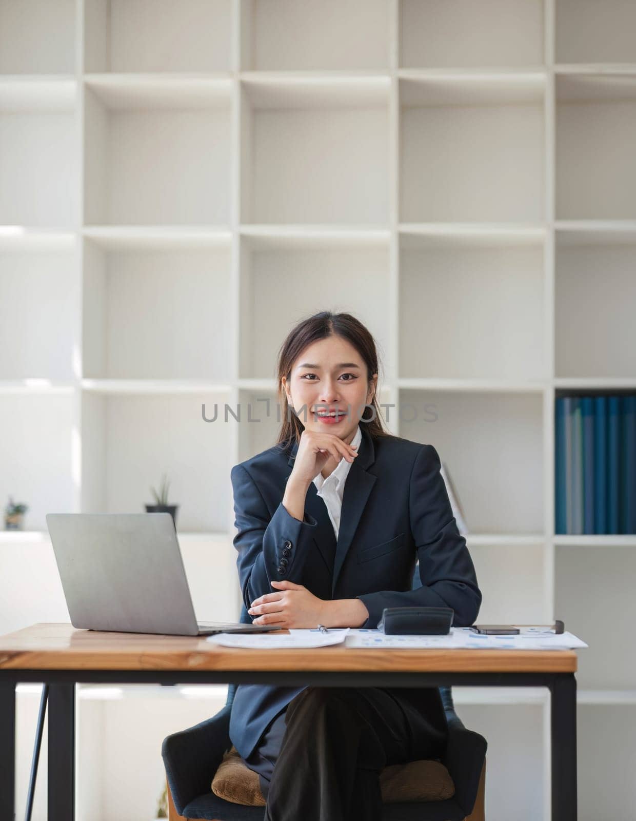Portrait of accountant woman working on financial strategy as growth at startup company with smile. by wichayada