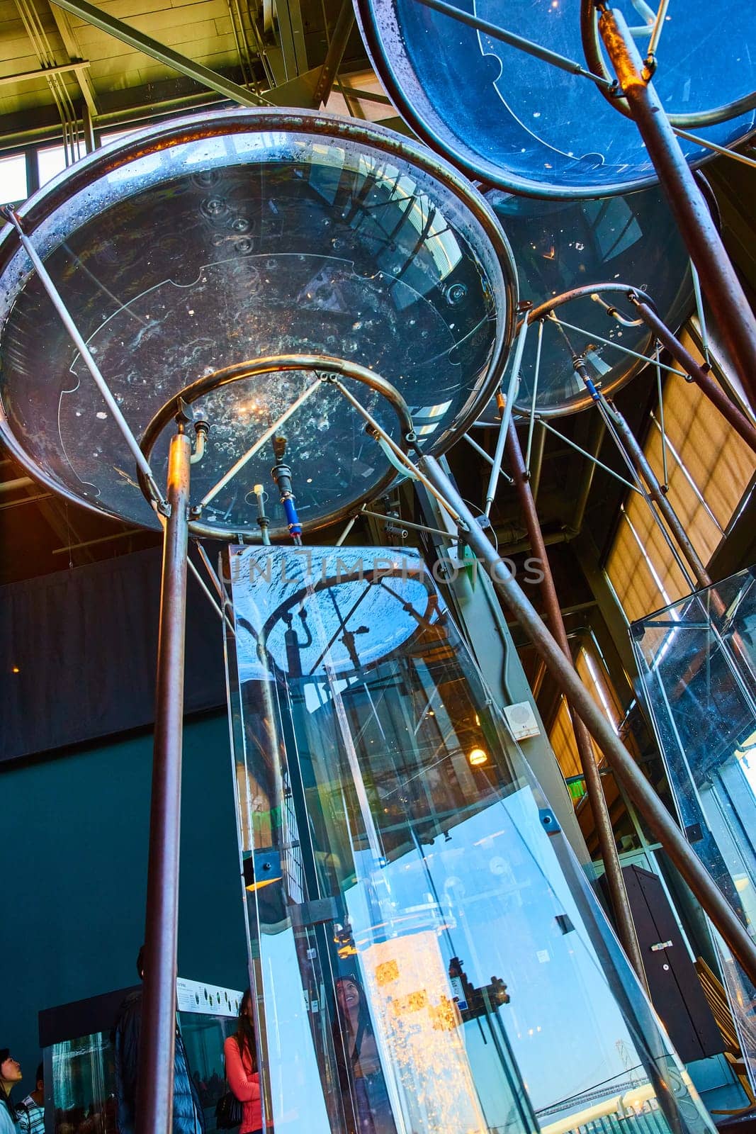 Image of Bubbling water in large clear bowl on tall copper legs in science experiment