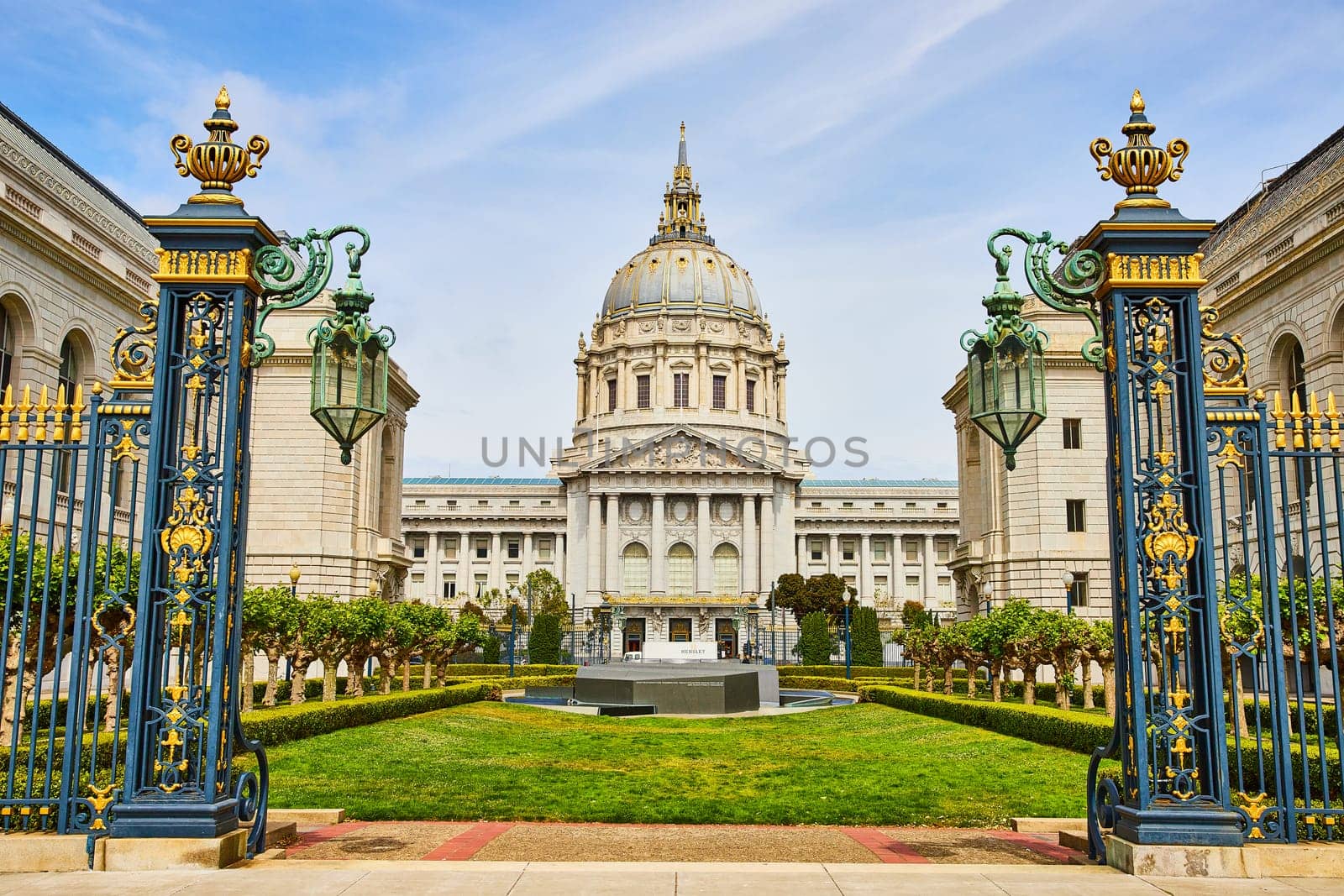 Image of San Francisco city hall memorial court with stone memorial view through gilded light posts