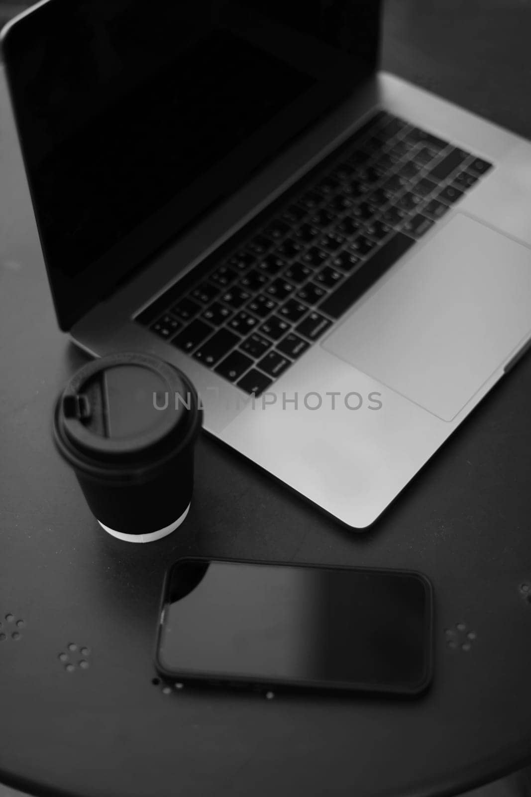 Desk office with laptop, phone, coffee cup, pen on black table. Flat lay top view copy space. Home office. Inspiration moment, workspace or coffee break in the morning. selective focus. by paralisart