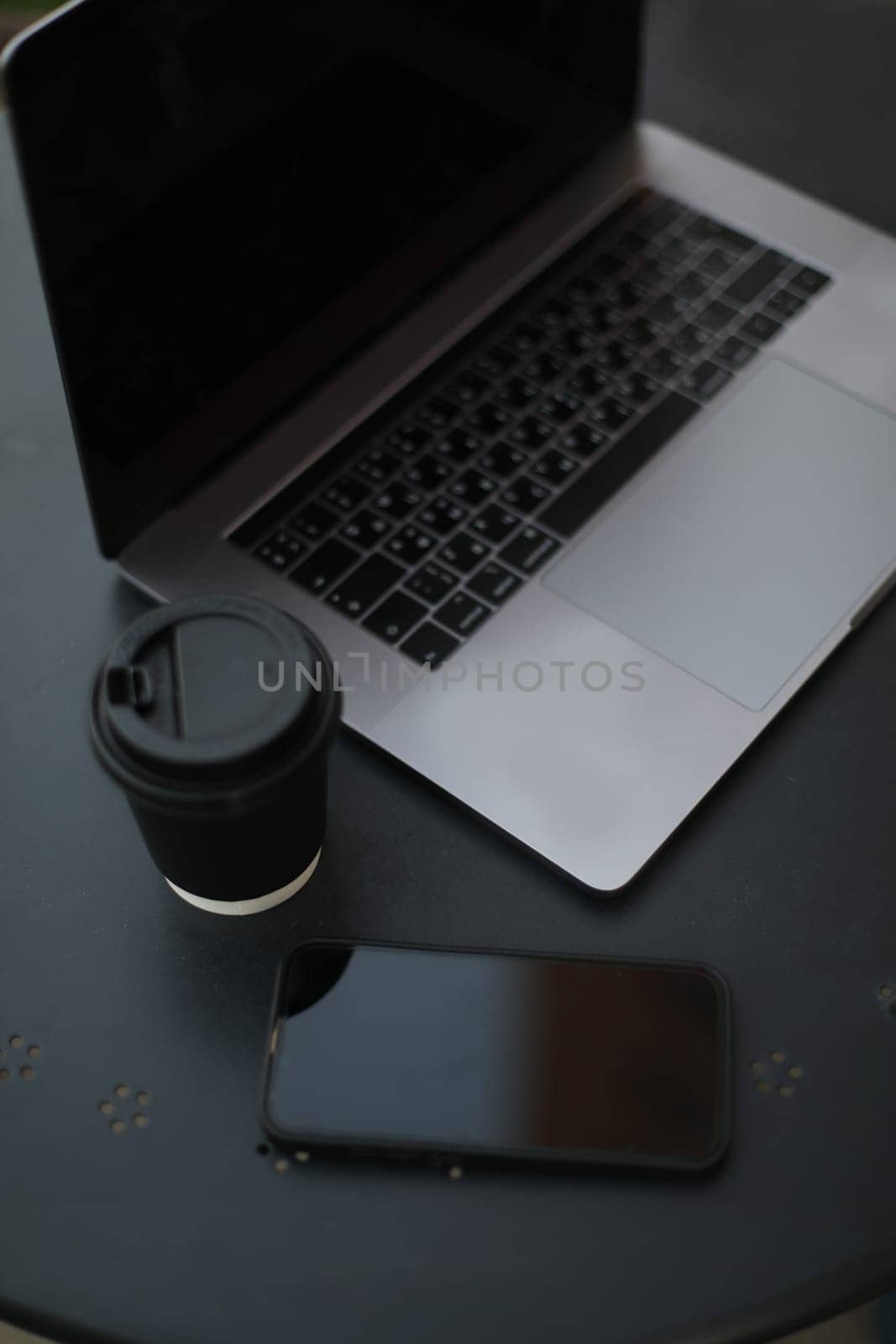 Desk office with laptop, phone, coffee cup, pen on black table. Flat lay top view copy space. Home office. Inspiration moment, workspace or coffee break in the morning. selective focus. by paralisart