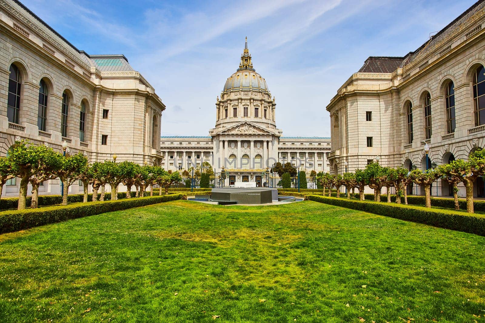 Image of Grassy green memorial court of San Francisco city hall with memorial on sunny day