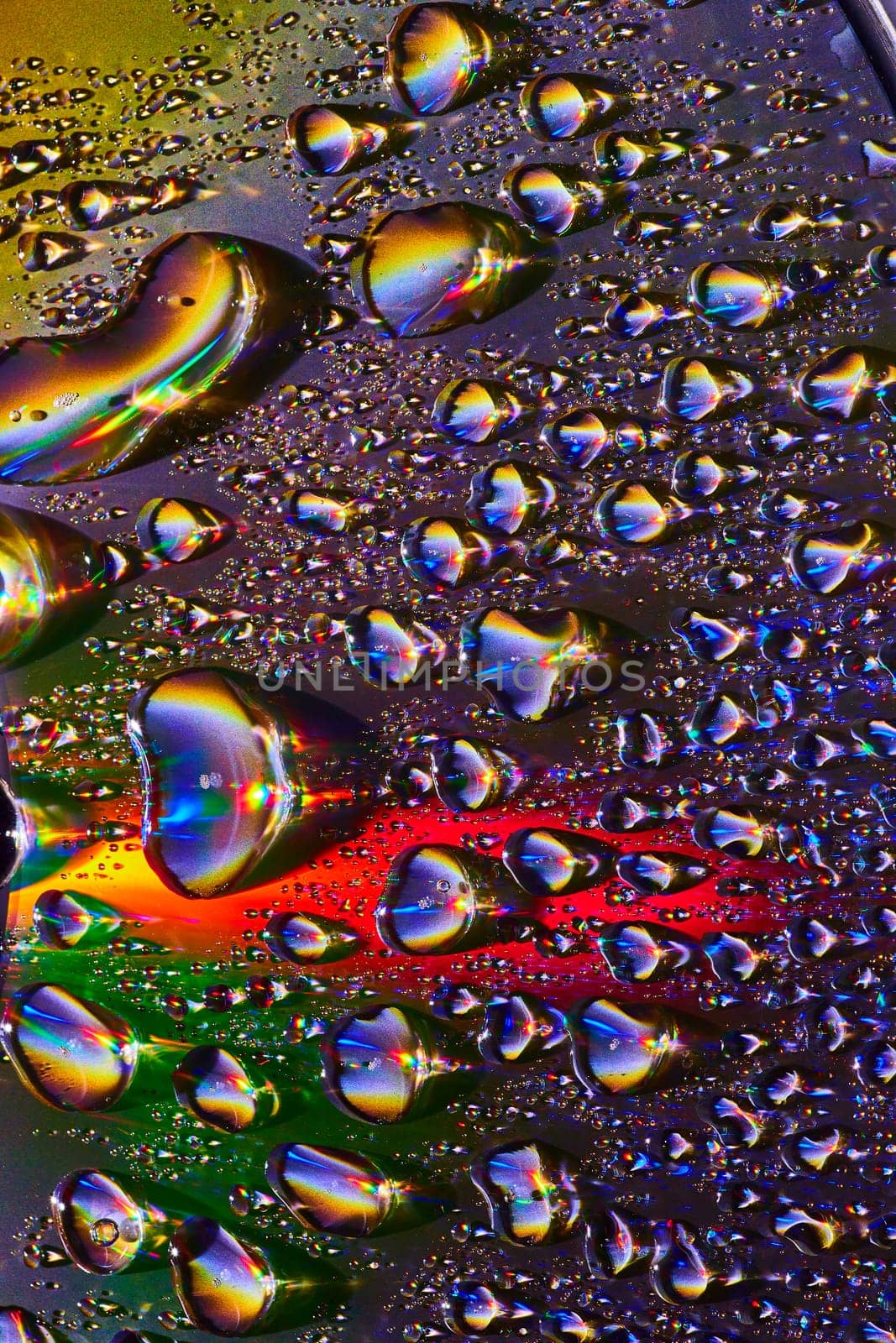 Image of Burst of fizzy soda bubbles with metallic surface and rainbow colors in dark background asset