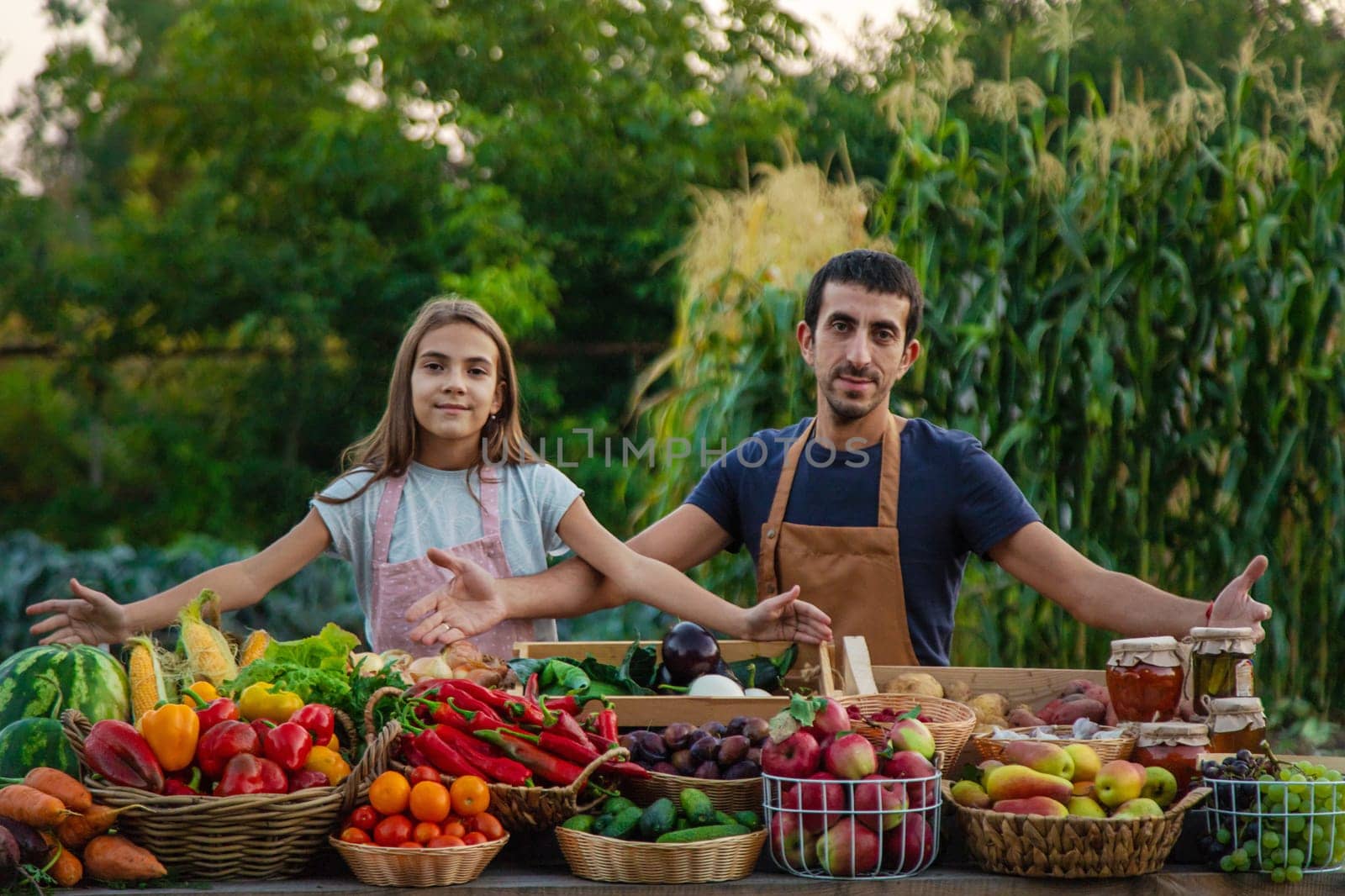 Father and daughter sell vegetables and fruits at the farmers market. Selective focus. food.