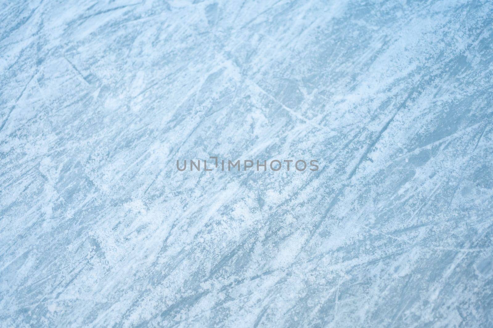 Winter frost patterns on glass. Ice crystals or cold winter background. Frozen snow window. Blue ice frost clings to glass, forming intricate patterns. Intricate and delicate designs created by frost