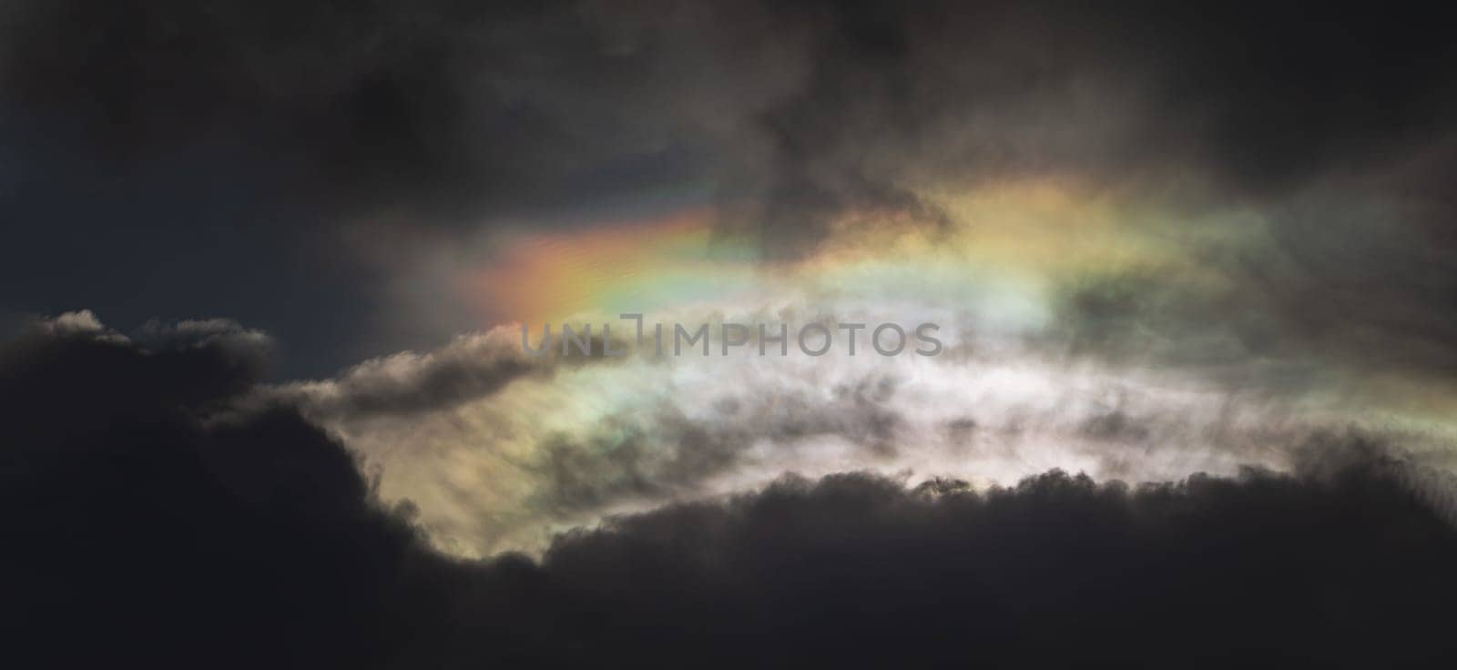 The sun's rays passing through the clouds and shining form an interesting light pattern against the sky. Amazing clouds like a heaven for background wallpaper and texture, Nature abstract composition, Panoramic shot, Selective focus.