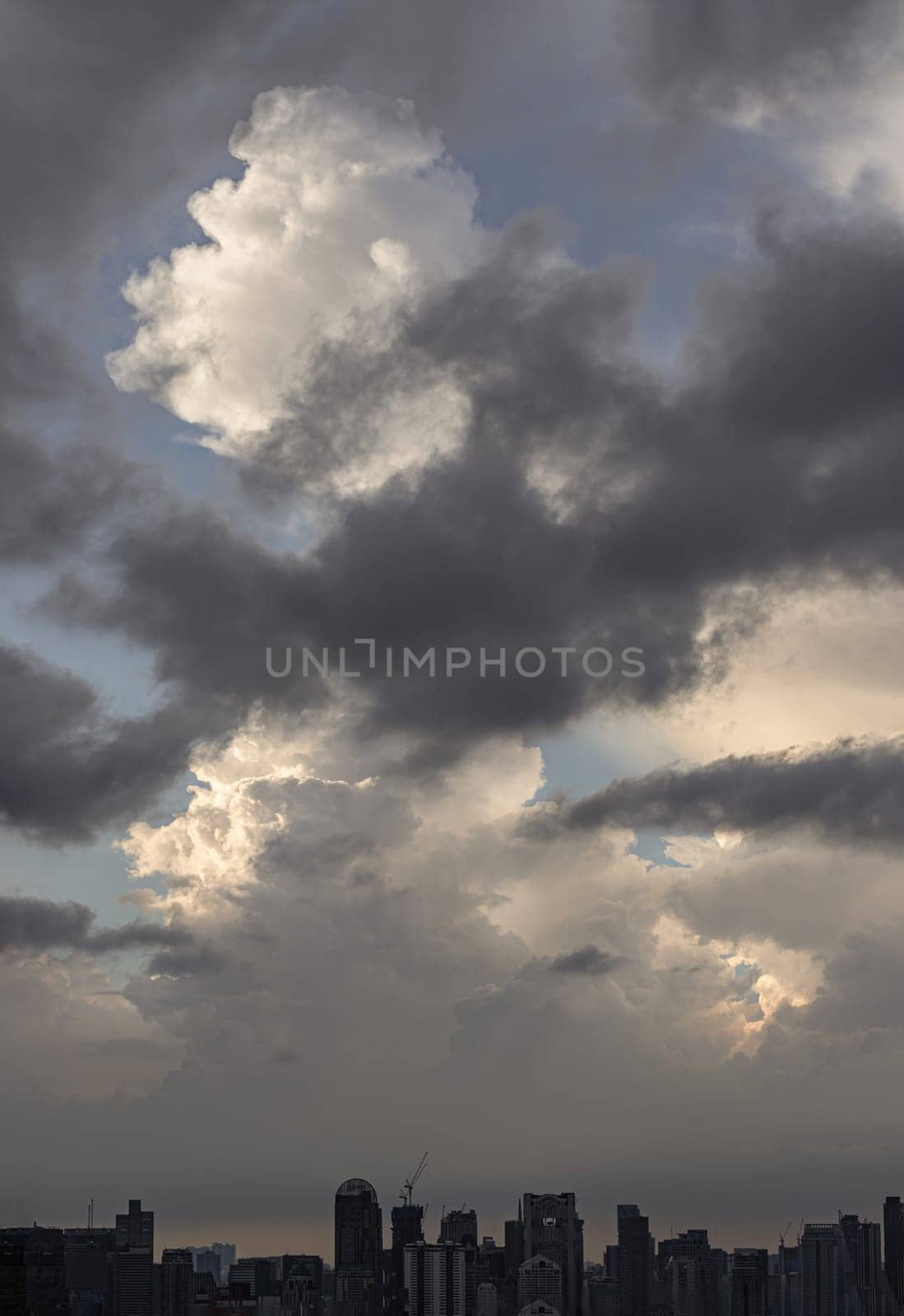 Bangkok, Thailand - 04 Aug 2024 - Beautiful Clouds in the Sky over Large Metropolitan City of Bangkok. View of Skyscrapers and Dramatic Sky before Sunset, Space for text, Selective focus.