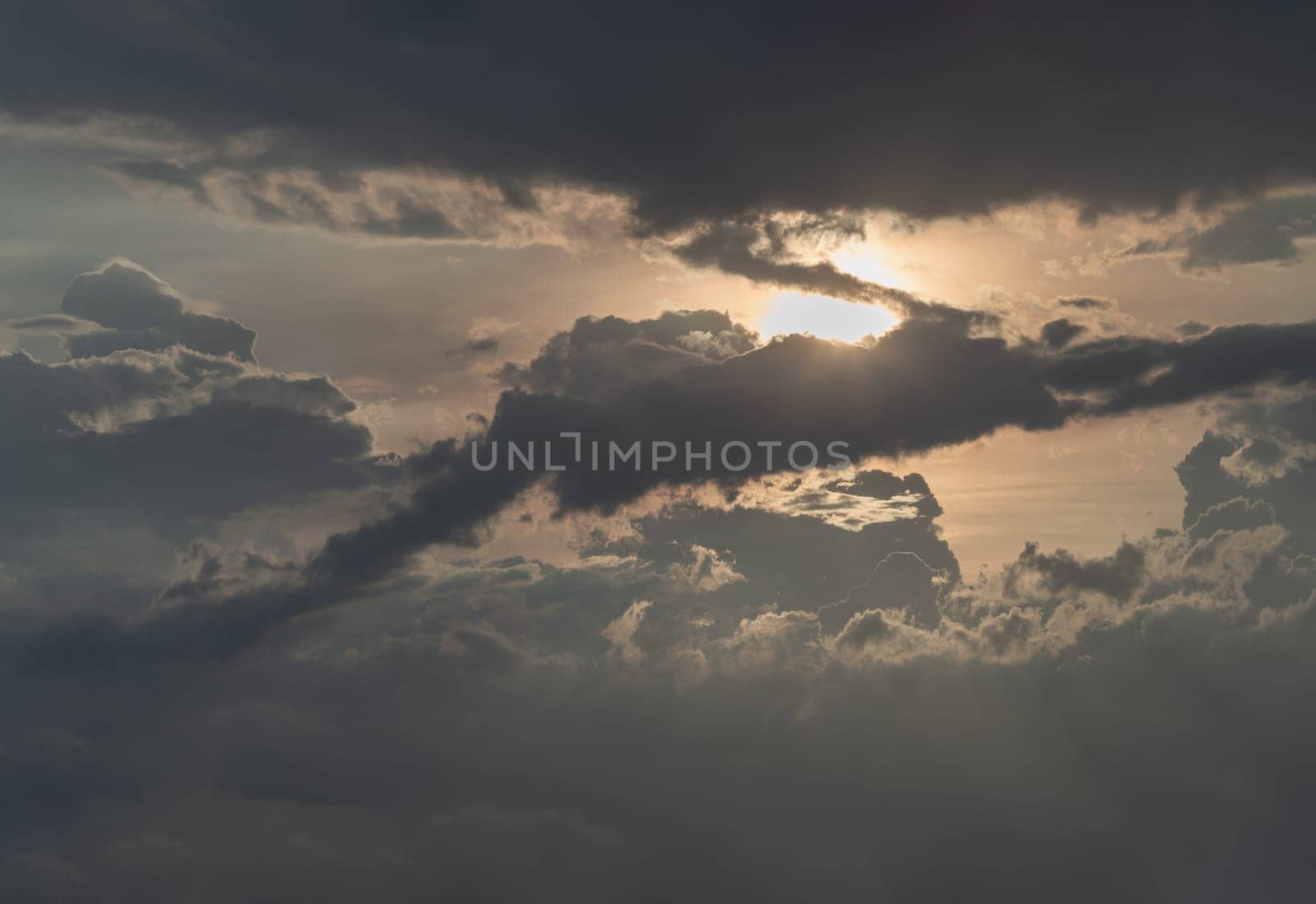 The sun's rays passing through the clouds and shining form an interesting light pattern against the sky. Amazing colors sky and clouds for background wallpaper and texture, Nature abstract composition, Selective focus.