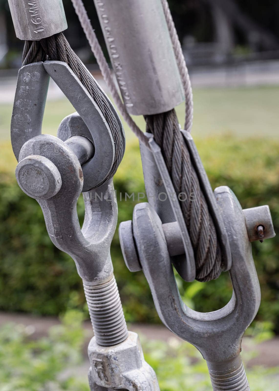 Steel wire rope slings with Thimble and safety anchor shackle turnbuckle connection bolt for heavy work. Metal ring and Steel cabling attached to a shackle, Device for adjusting the tension or length cable, Copy space, Selective Focus.