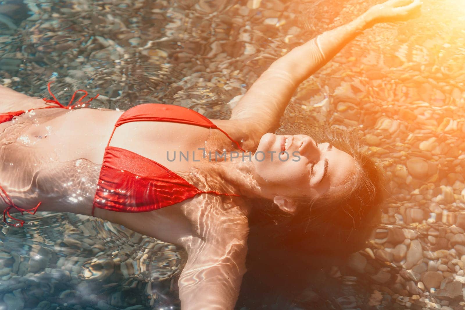 Weight loss and body image concept. Woman with perfect fit body walking confident on beach. Unrecognizable sexy young woman.