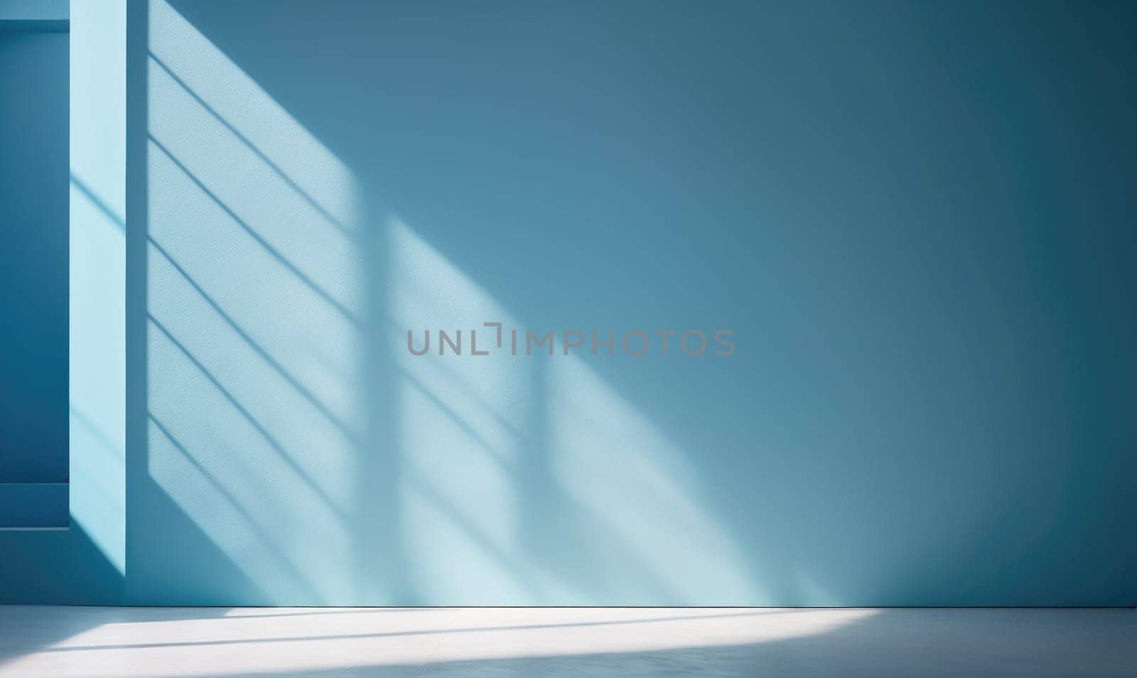 A wide shot of a blue wall with a white floor. Sunlight from a window shines through the room, creating a pattern of light and shadow on the wall.