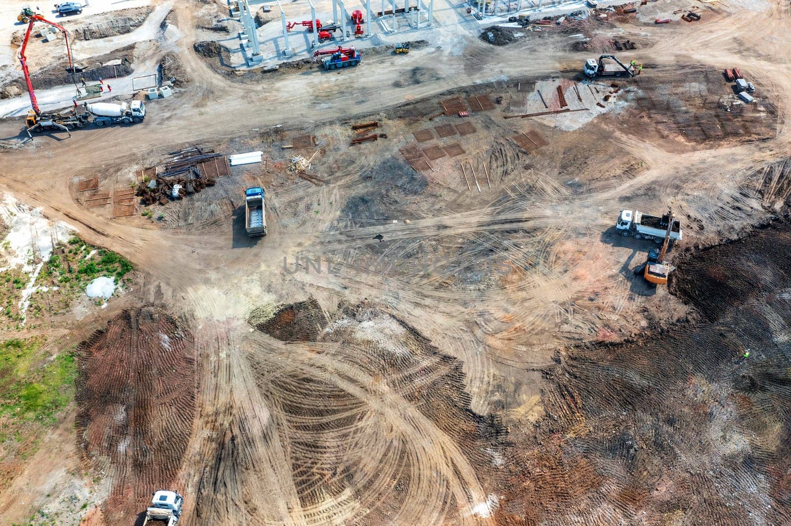 Aerial top view of big construction site with many working heavy machines