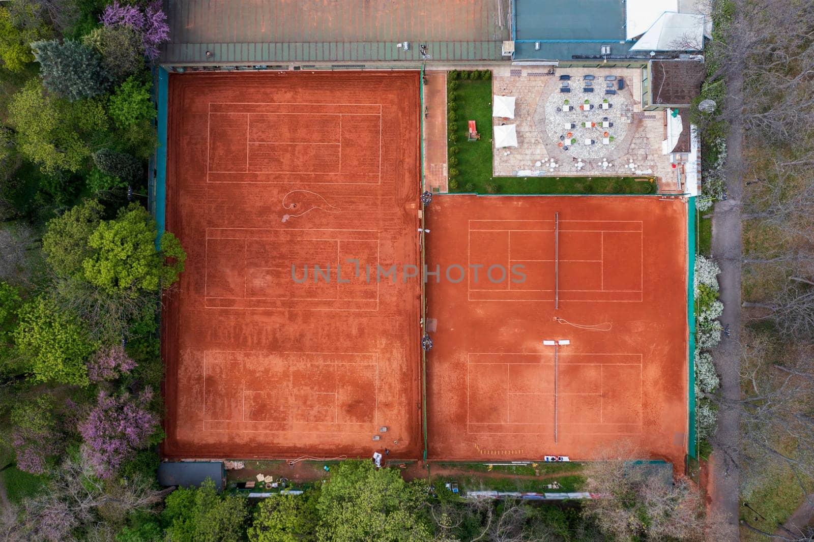 Clay courts for playing tennis in the park, aerial view. 