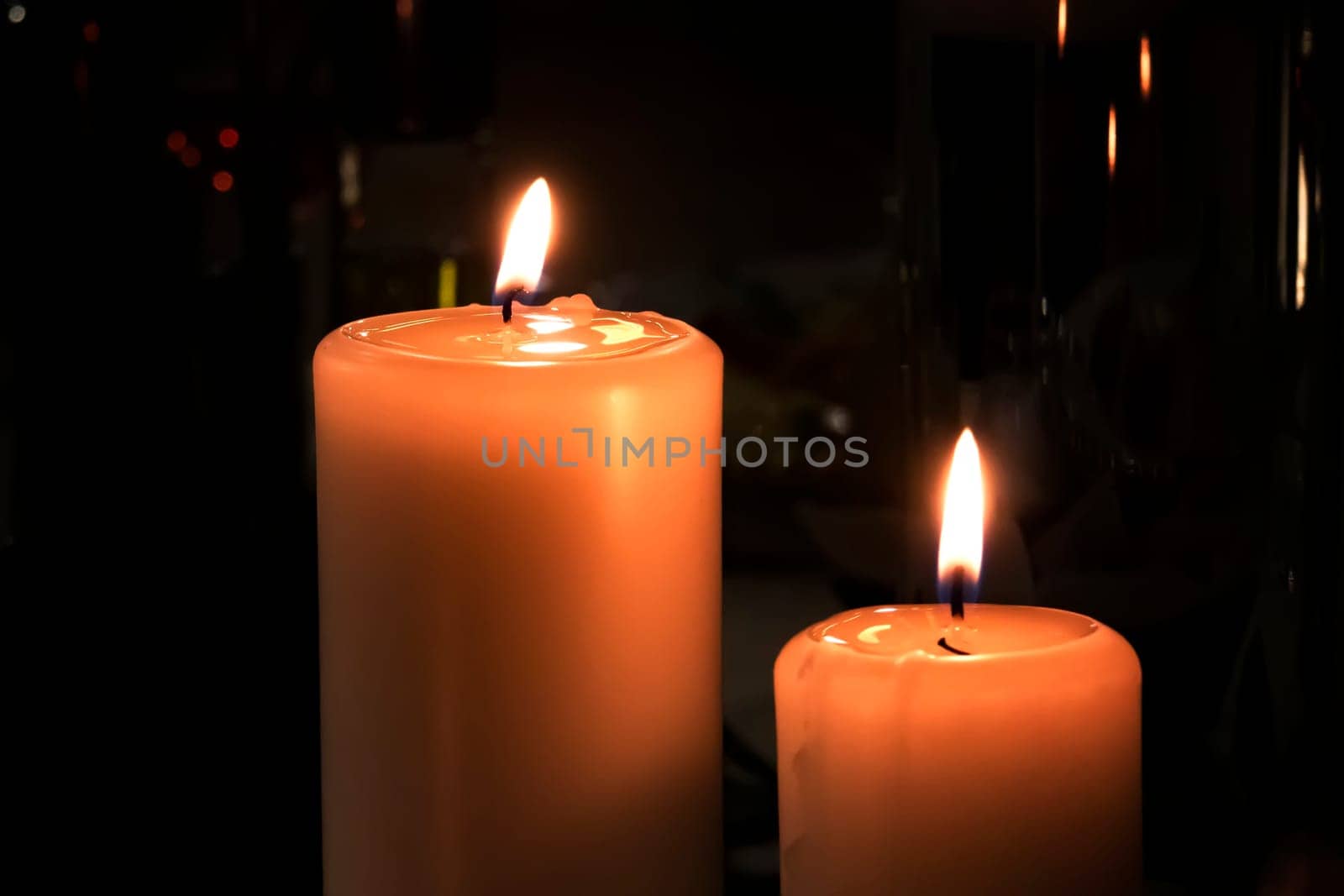 Two shiny Candles on black background