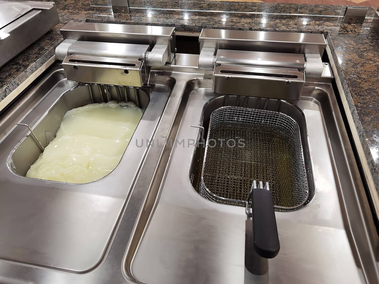 Big fryer for potatoes with cold and warm oil. Concept fast food restaurant,  kitchen equipment 