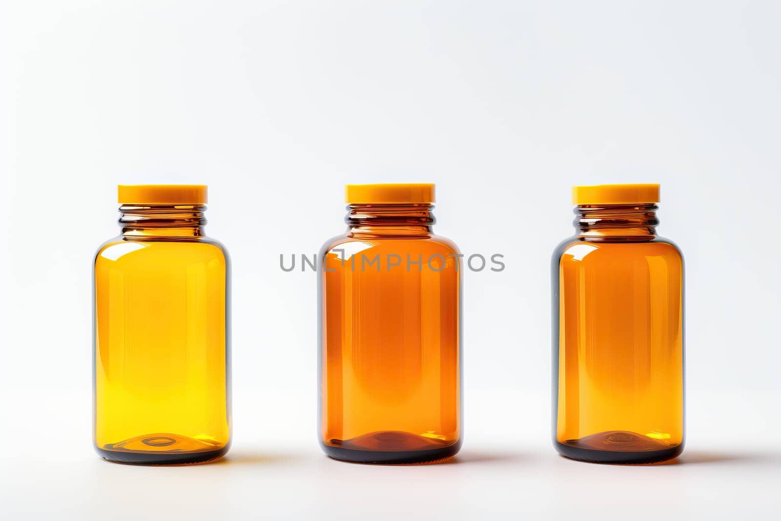 Three amber glass bottles with yellow caps on white background. Medicine, pharmacy, and healthcare concept.