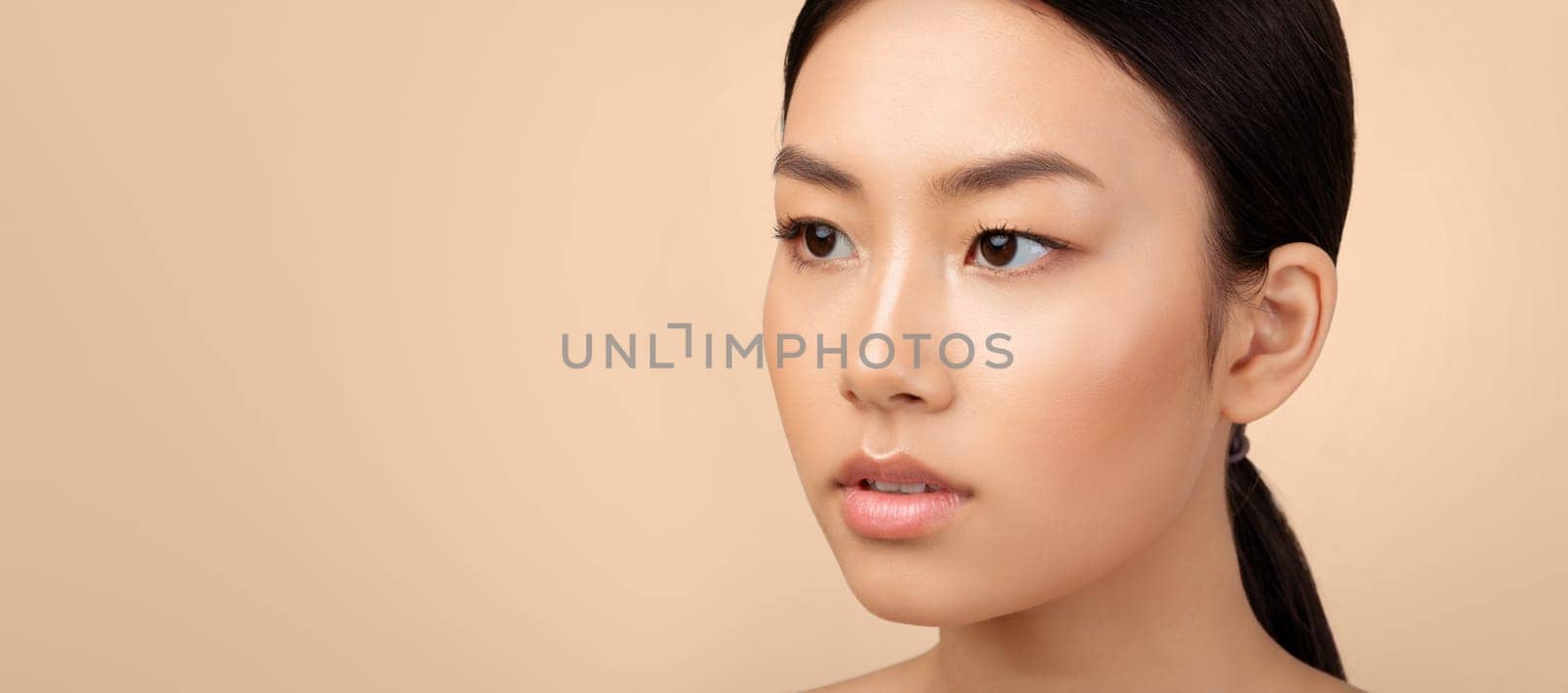 Beauty Portrait Of Attractive Asian Lady Looking Aside At Free Space Over Light Gray Studio Background. Closeup Of Young Woman's Face With Perfect Smooth Skin And Makeup. Panorama