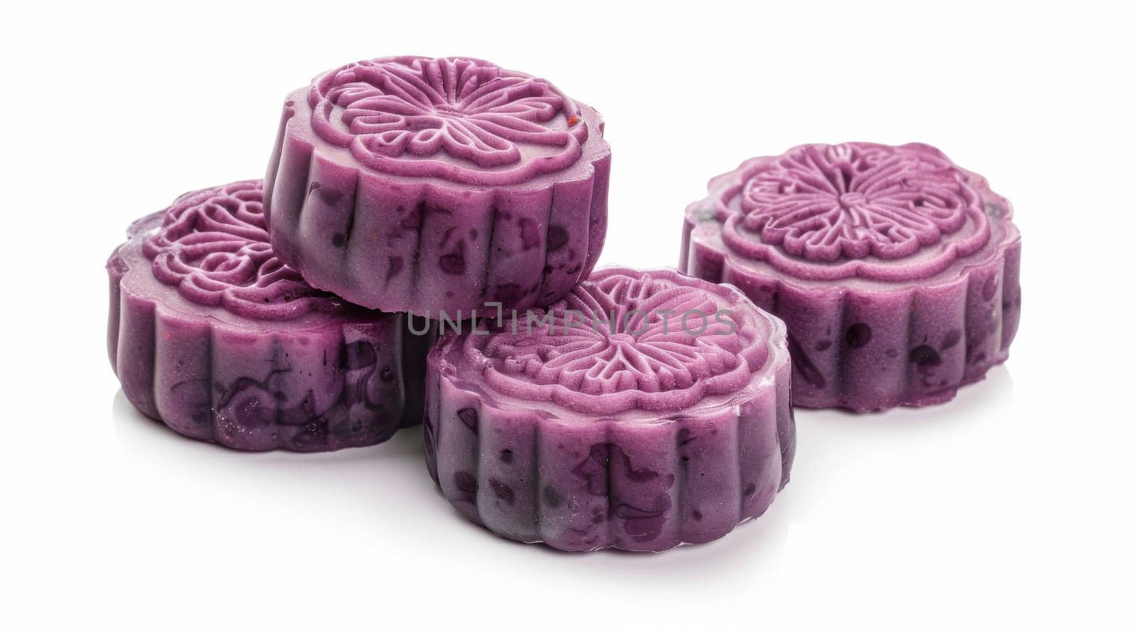 Delicious purple mooncakes beautifully arranged isolated on white