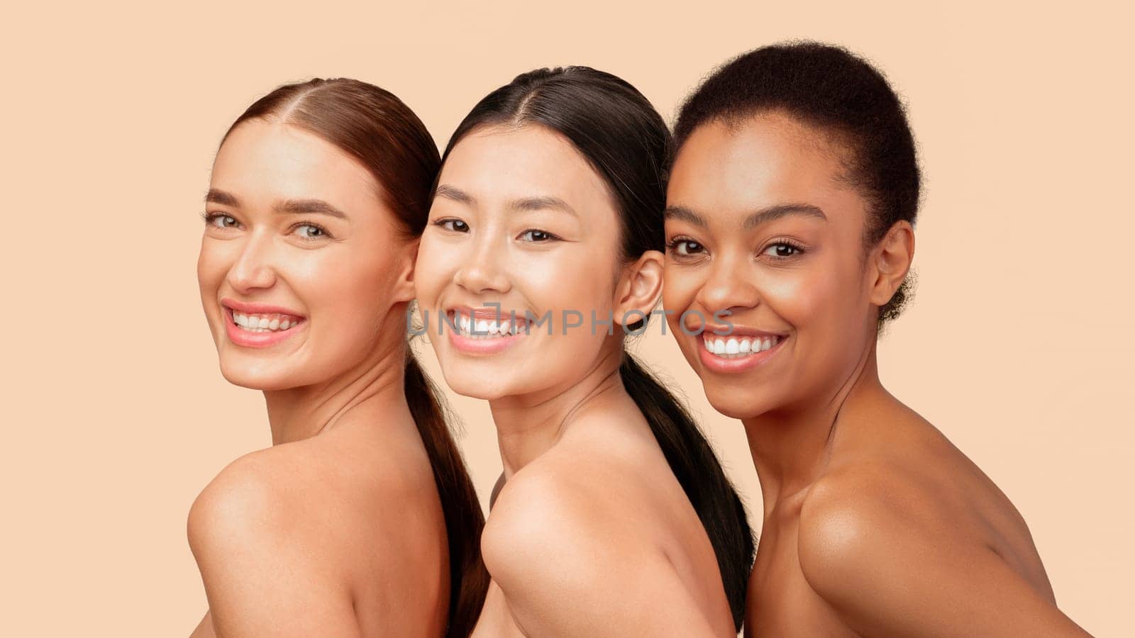 Beauty And Skincare. Portrait Of Three Multiethnic Girls Smiling At Camera Posing Over White Studio Background. Panorama