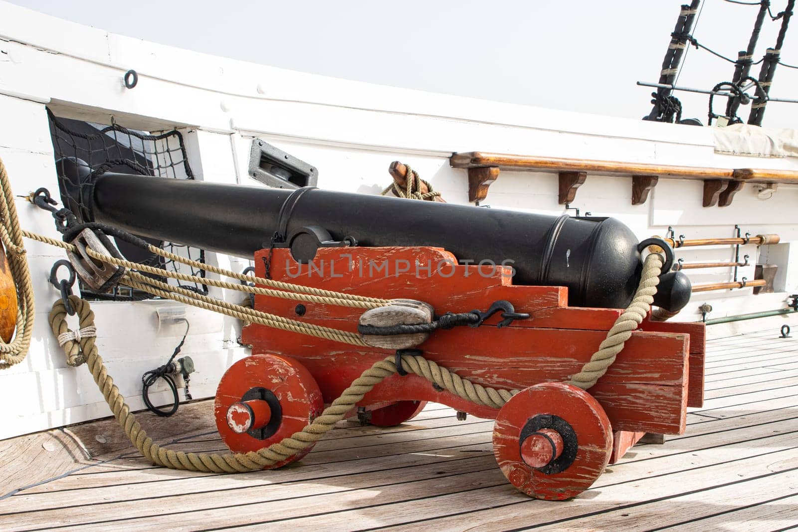 Historirical retro metal cannon on battle sailing vessel - stand on deck