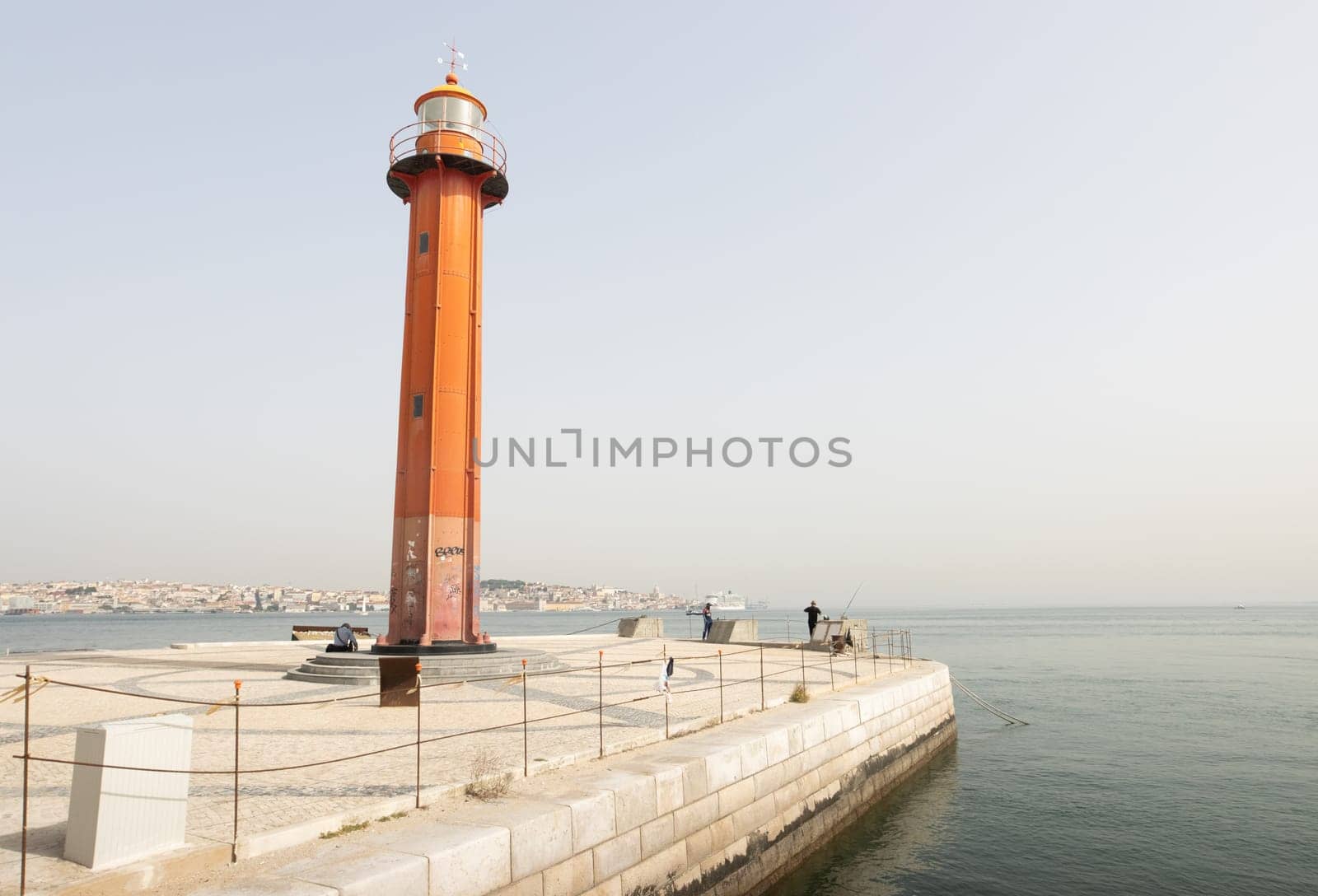 Lisbon, Portugal - 0510 2022 - Lighthouse on coast of Almada, view of Lisboa harbor