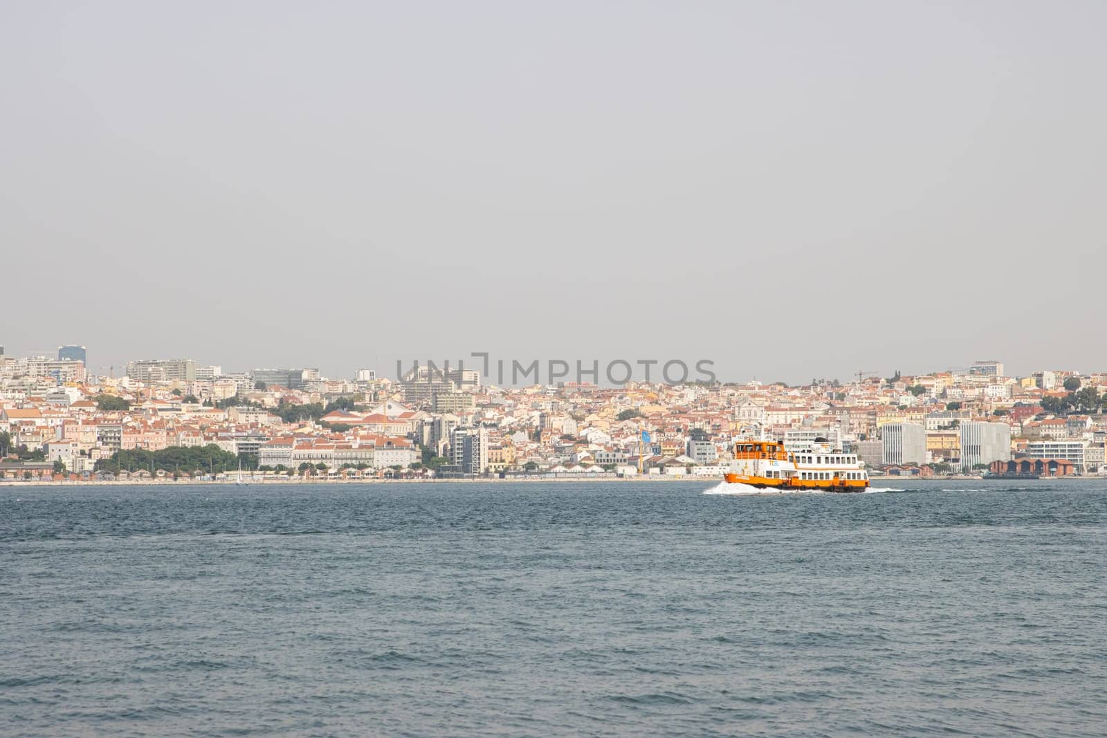 Lisbon, Portugal - 0510 2022 - Touristic ferry boat arriving to the station Almada, Lisboa Harbor