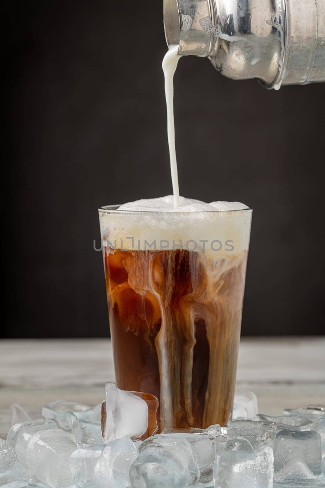 Iced coffee latte in glass cup on wooden table