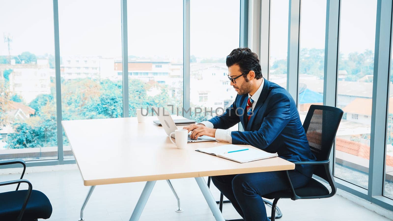 Business people working at table in modern office room while analyzing financial data report . Jivy