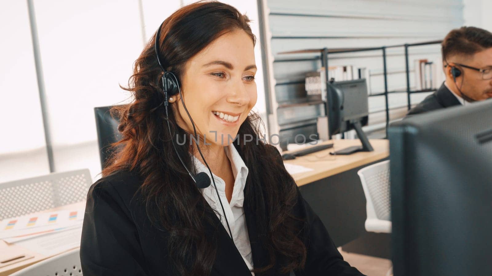 Business people wearing headset working in office to support remote customer or colleague. Call center, telemarketing, customer support agent provide service on telephone video conference call. Jivy