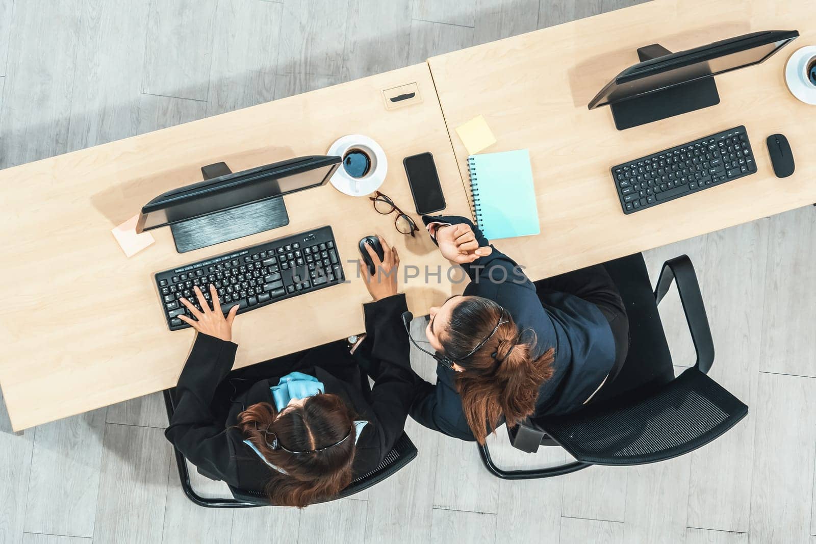 Business people wearing headset shot from top view in office working with computer. Jivy