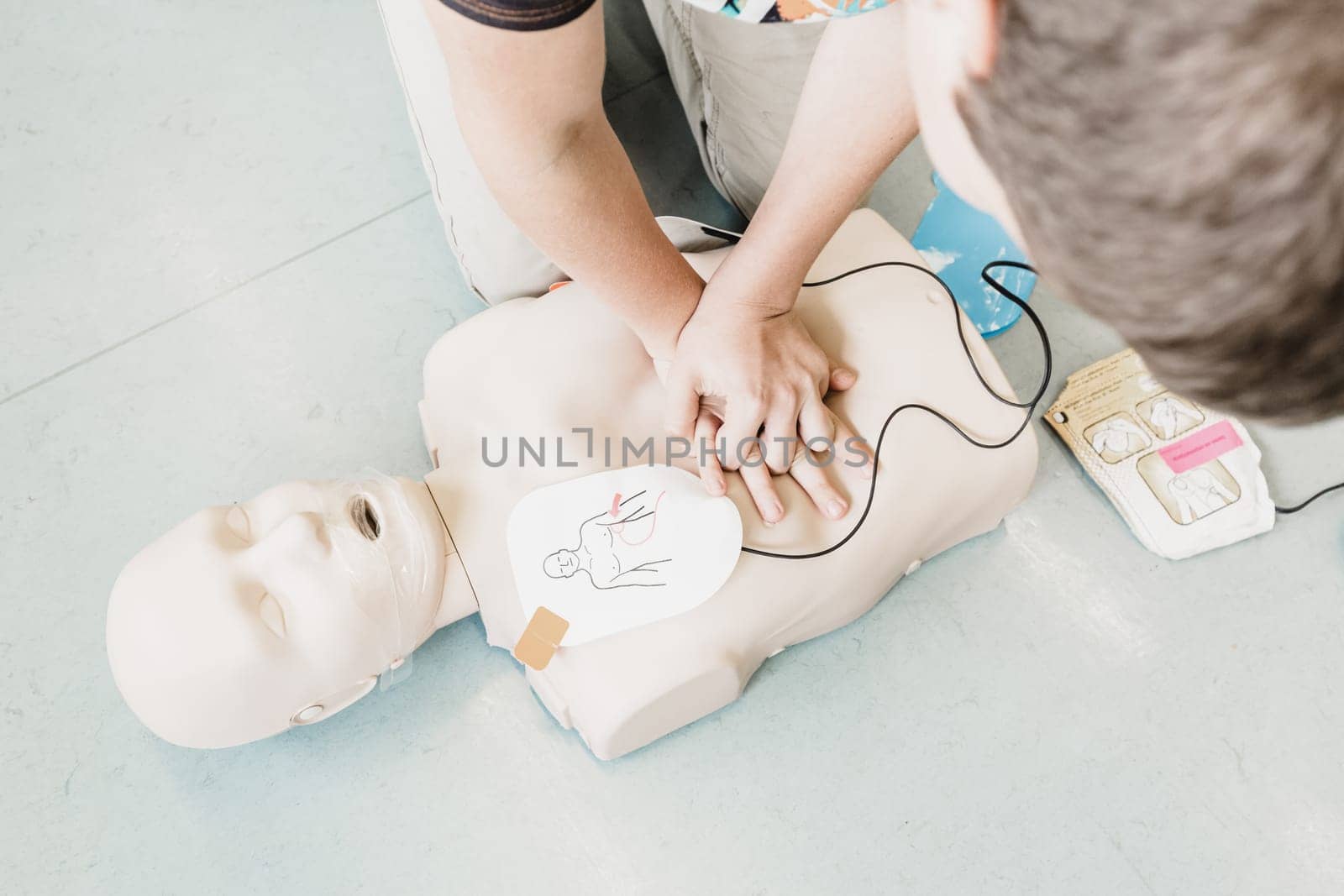 First aid cardiopulmonary resuscitation course using automated external defibrillator device, AED.