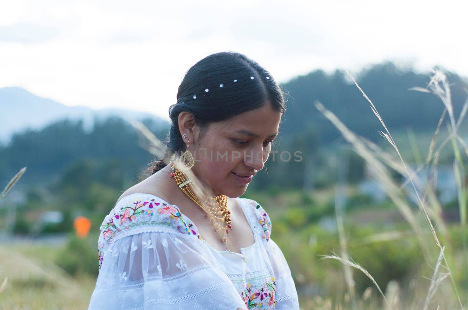 indigenous woman farmer in the field tending her garden.Hispanic Heritage Month by Raulmartin