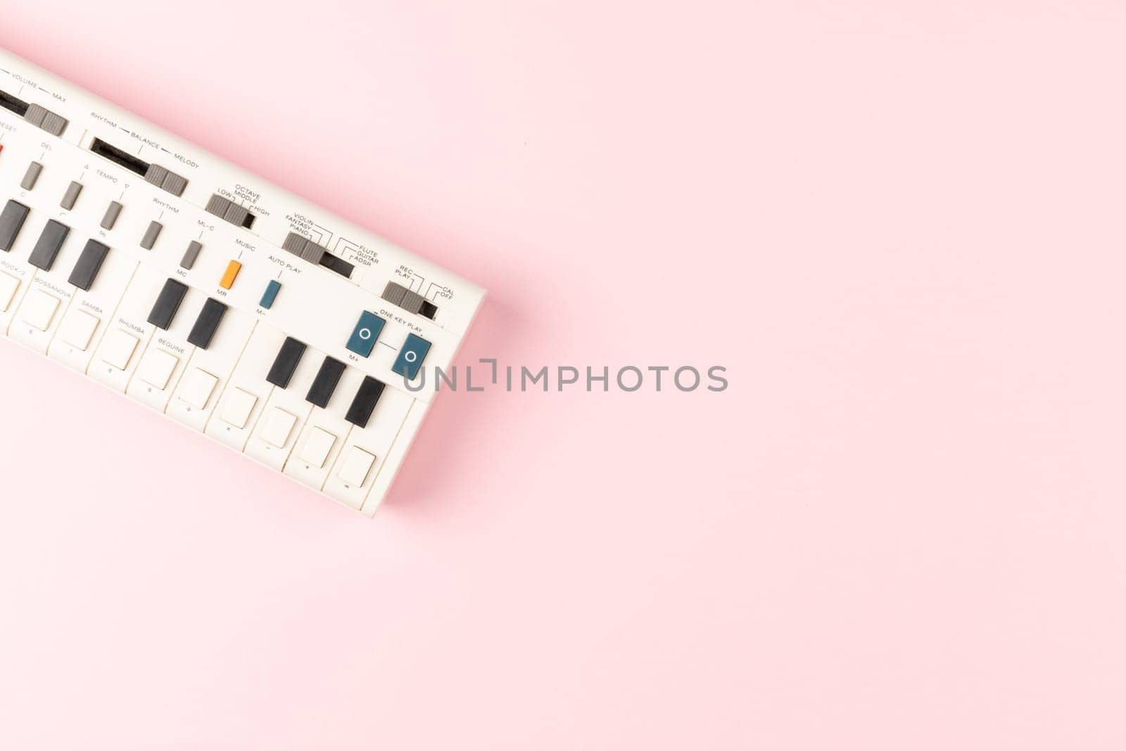 Vintage electronic keyboard synth piano on pink background by TropicalNinjaStudio