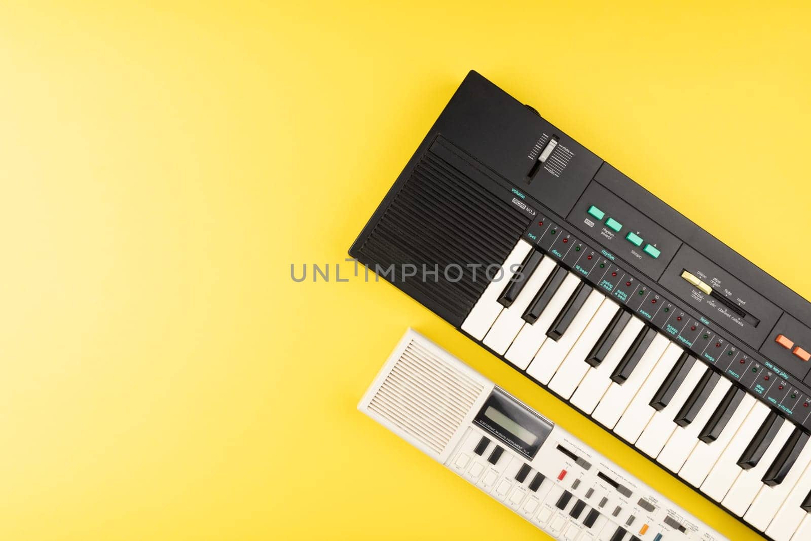 Vintage electronic keyboard synth piano on yellow background by TropicalNinjaStudio