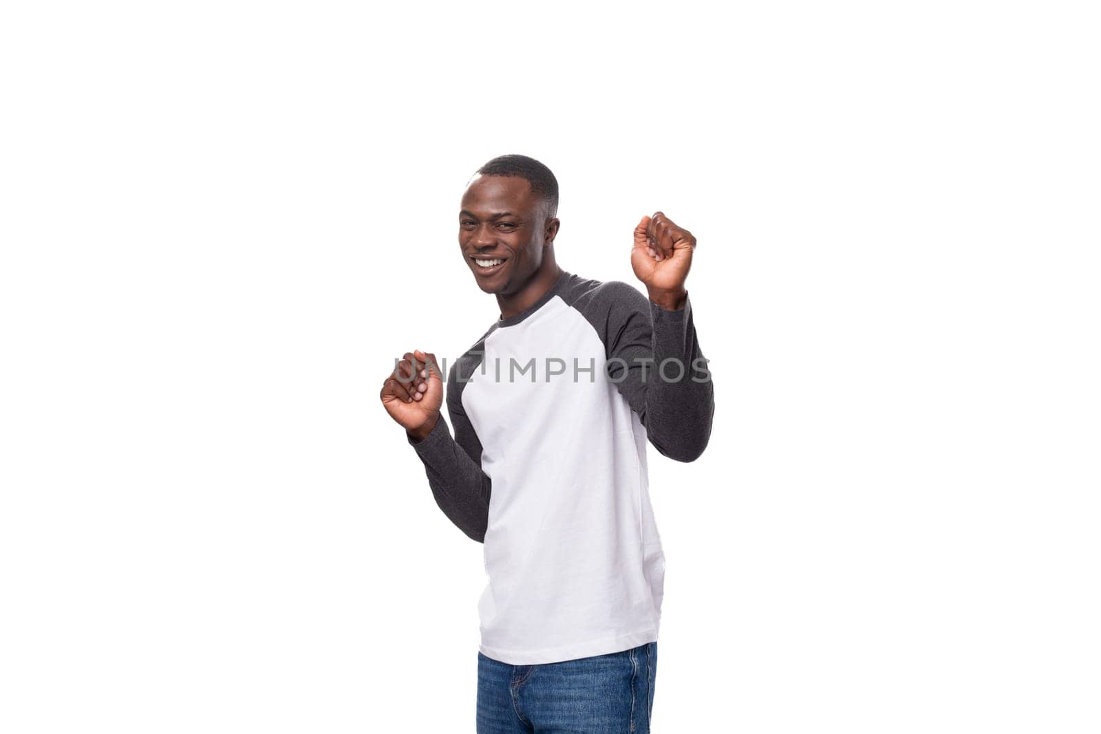 young modest cute american man with short haircut dressed in casual sweater on white background.
