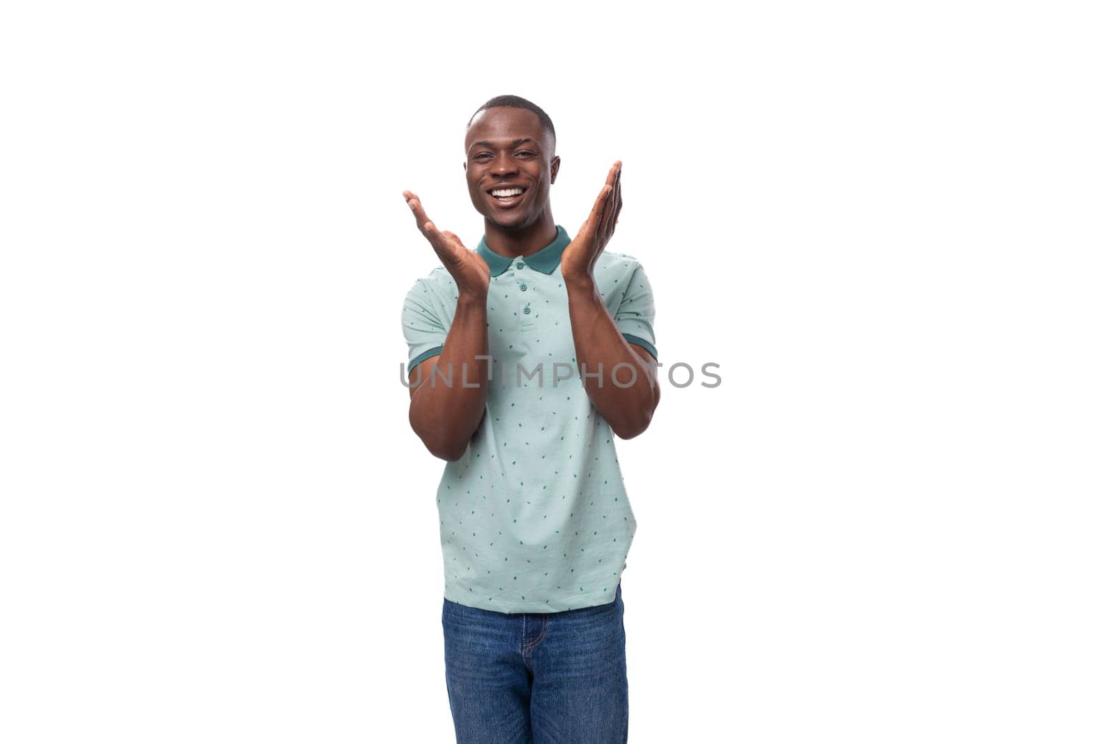 young friendly african guy with short haircut wearing mint collared t-shirt smiling.