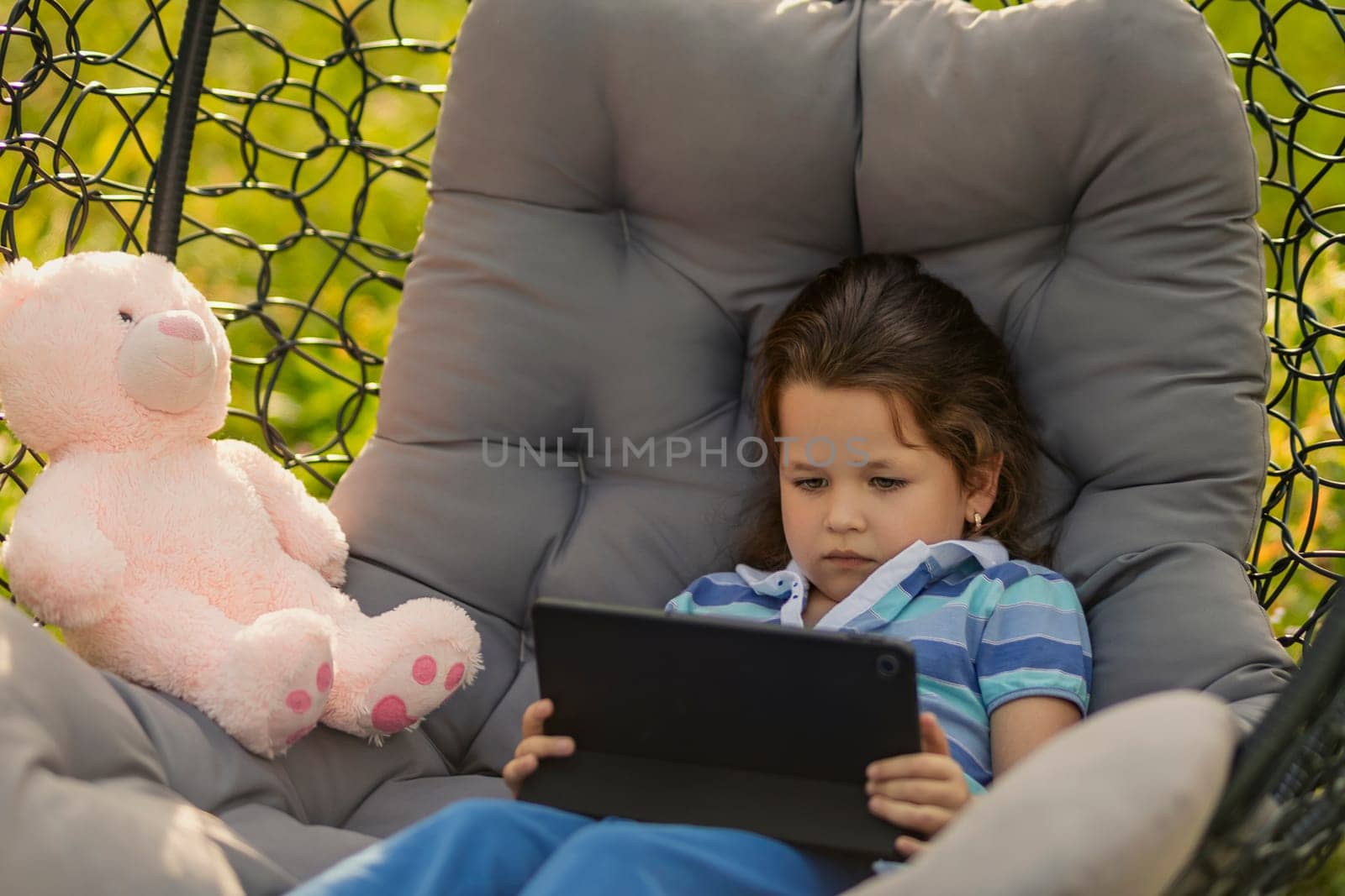 little girl looking at tablet, modern outdoor recreation