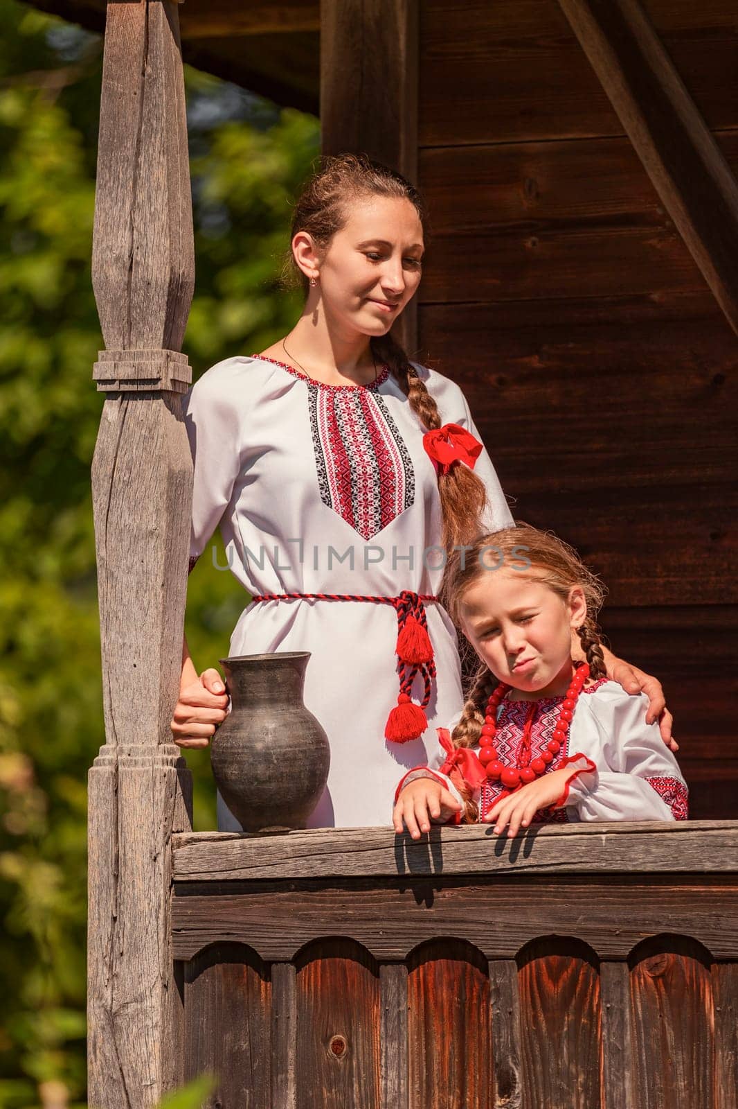 mother with daughter and jug in historical clothes